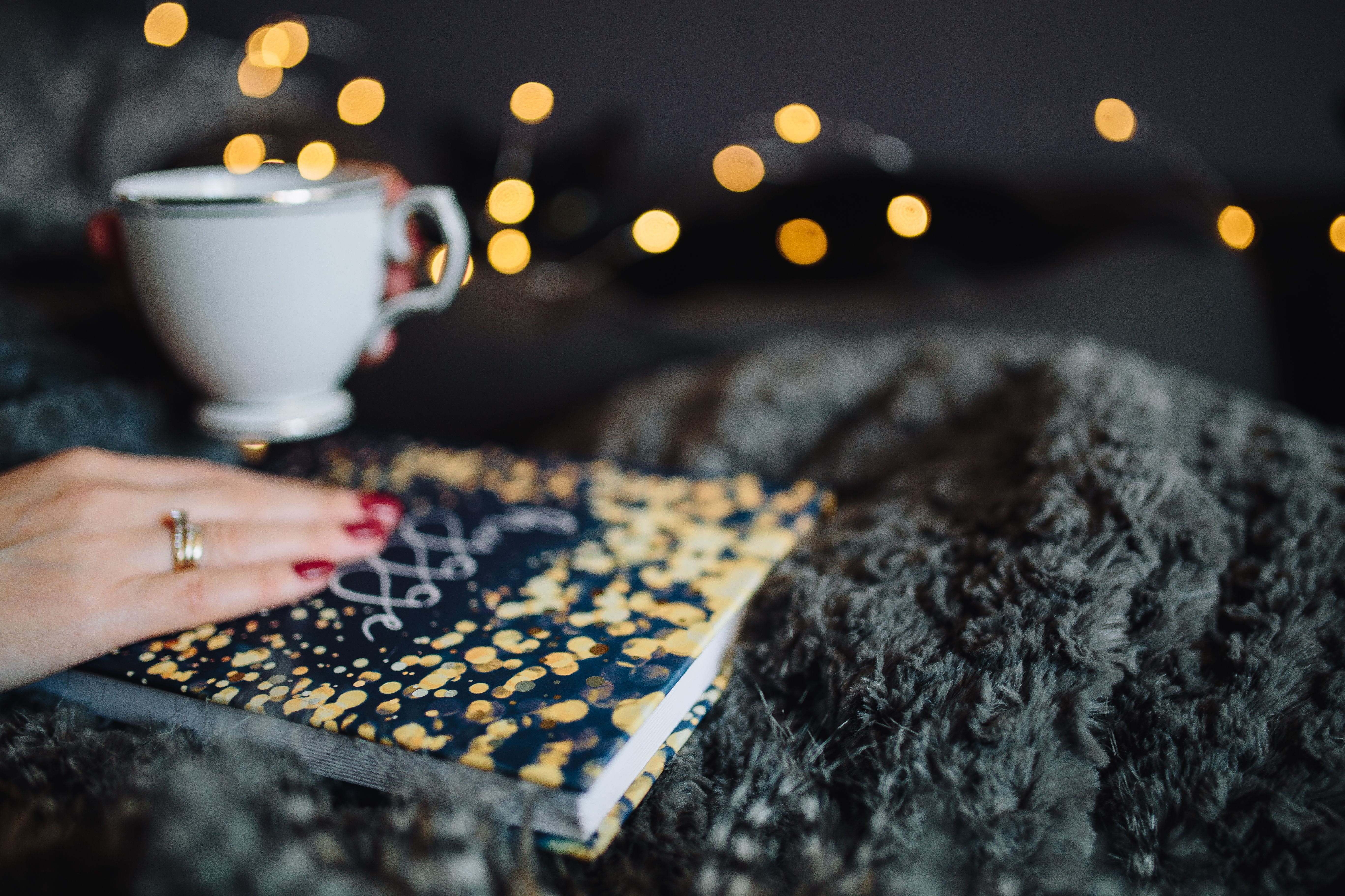 focus on foreground, woman, cup, coffee - Drink, human Hand, holding, reading, selective focus, illuminated, lifestyles, Hygge, people, mug, femine, indoor, HD Wallpaper