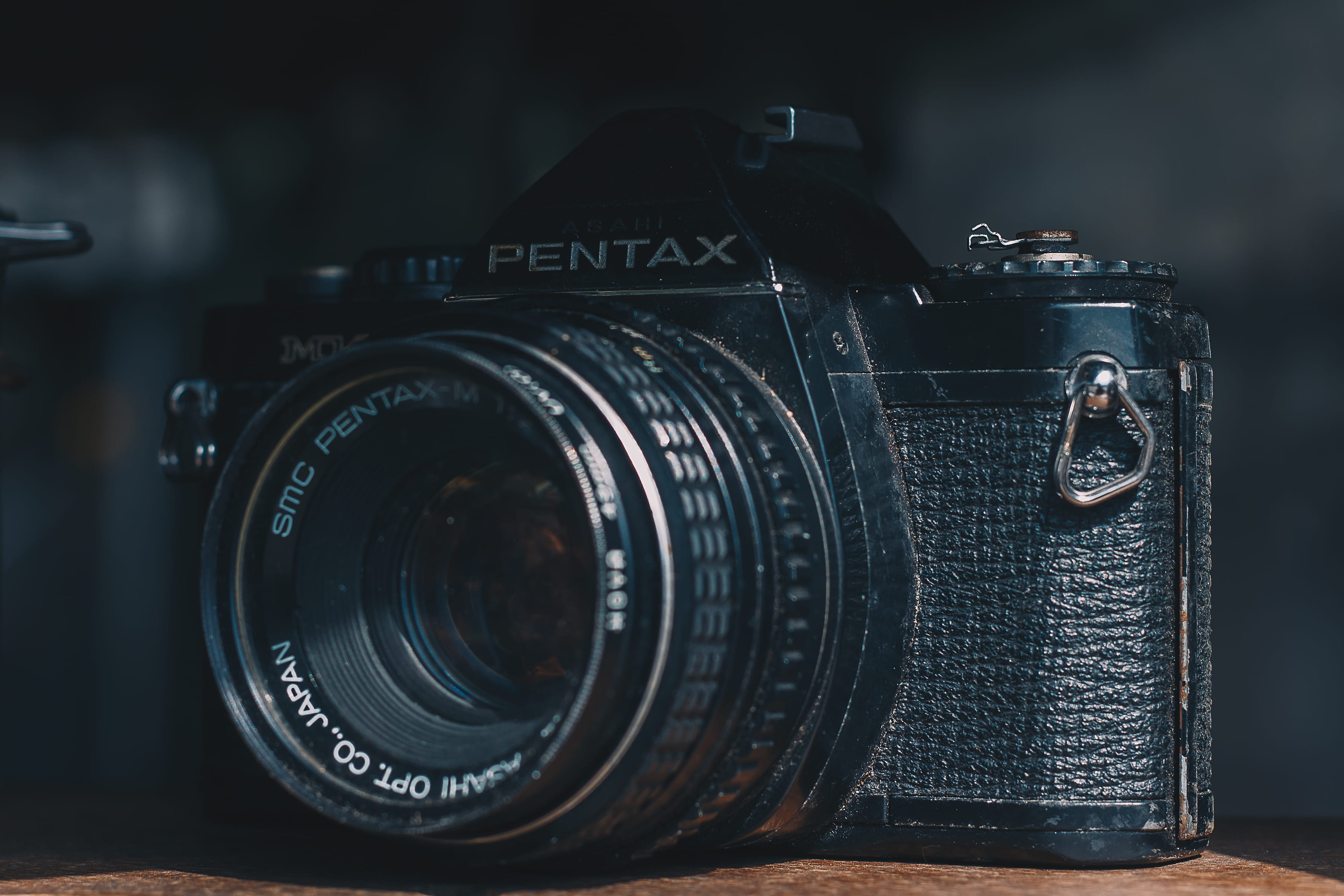 photographic equipment, camera, slr camera, aperture, retro styled, 2K, focus on foreground, close-up, antique, indoors, no people, table, single object, HD Wallpaper