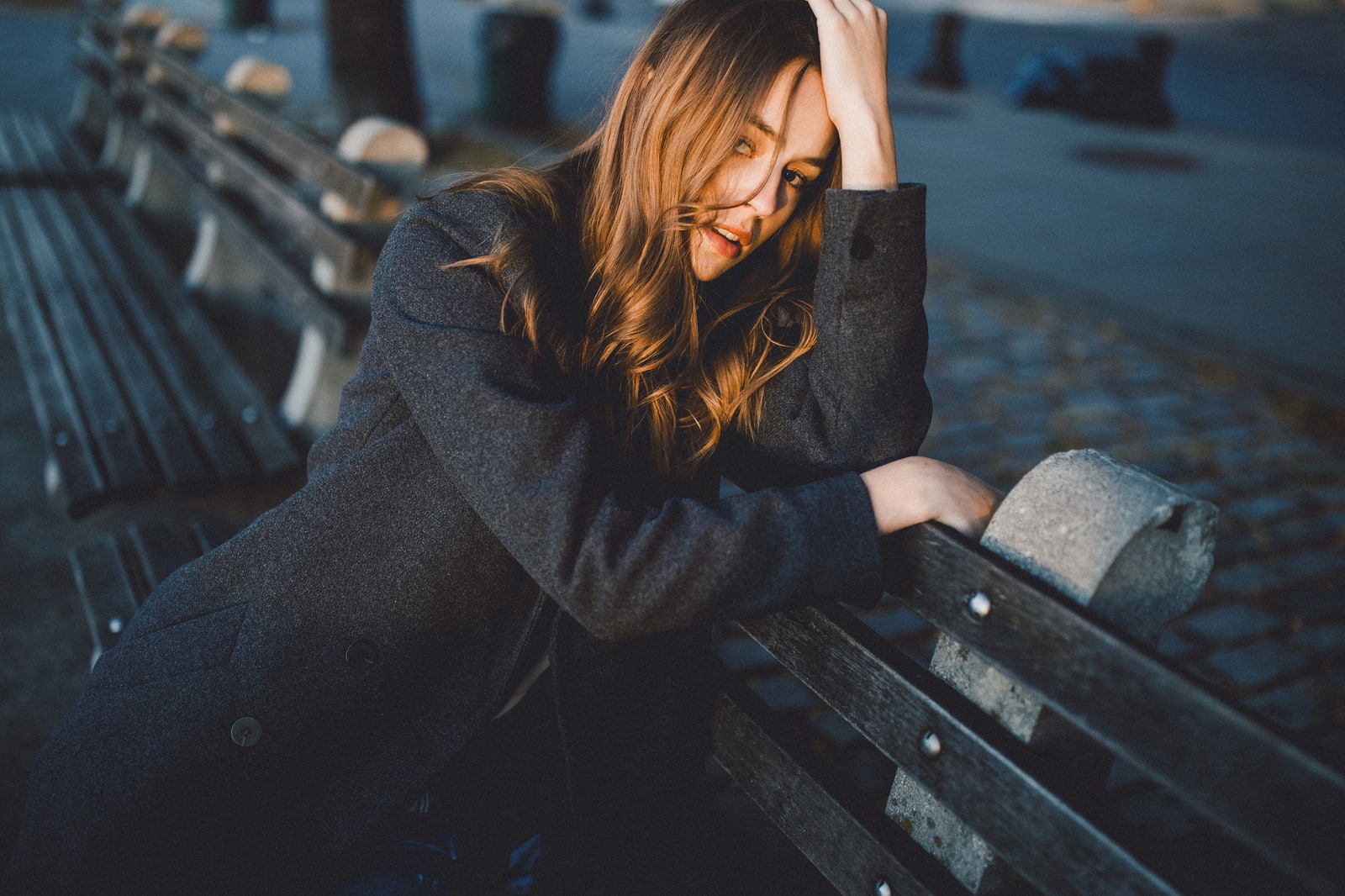women, sitting, women outdoors, SamAlive, brunette, coats, Caitlin Nusche, bench, 720P, overcoats, hair in face, depth of field, model, looking at viewer, HD Wallpaper
