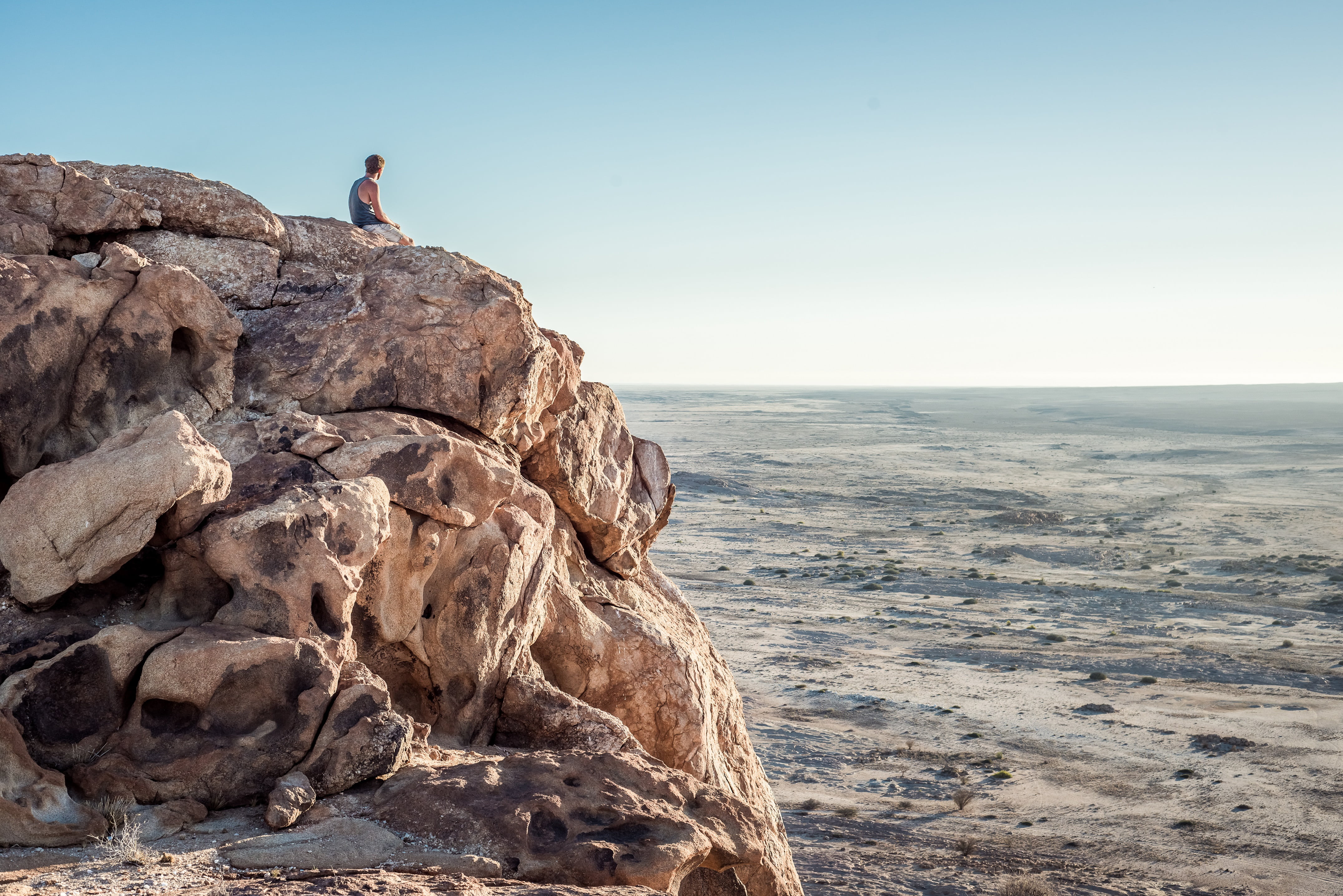 trek, 4K, leisure activity, beauty in nature, sitting, person, people, cliff, man, horizon, rock - object, travel, horizon over water, soil, rock, water, HD Wallpaper