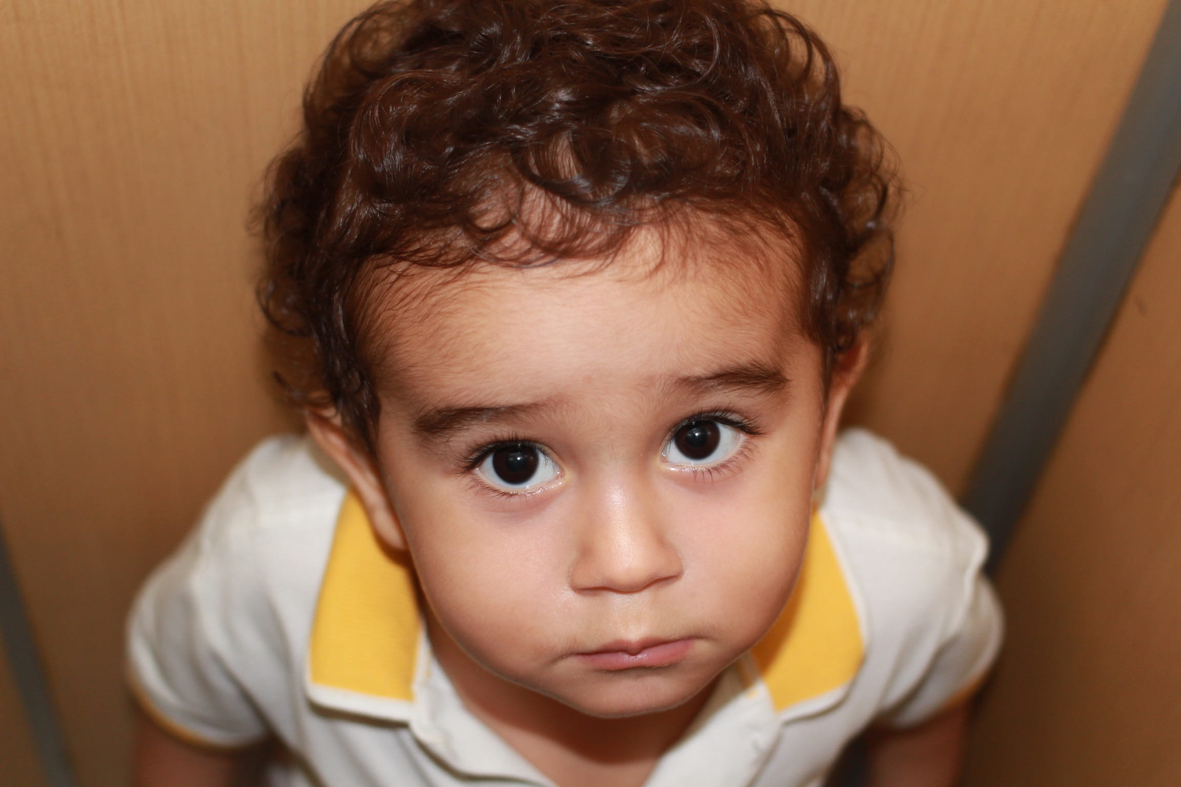 brown hair, close, child, yellow, guy, innocence, 1080P, contemplation, serious, sad, really, white, photography, human body part, small, cute, looking at camera, HD Wallpaper