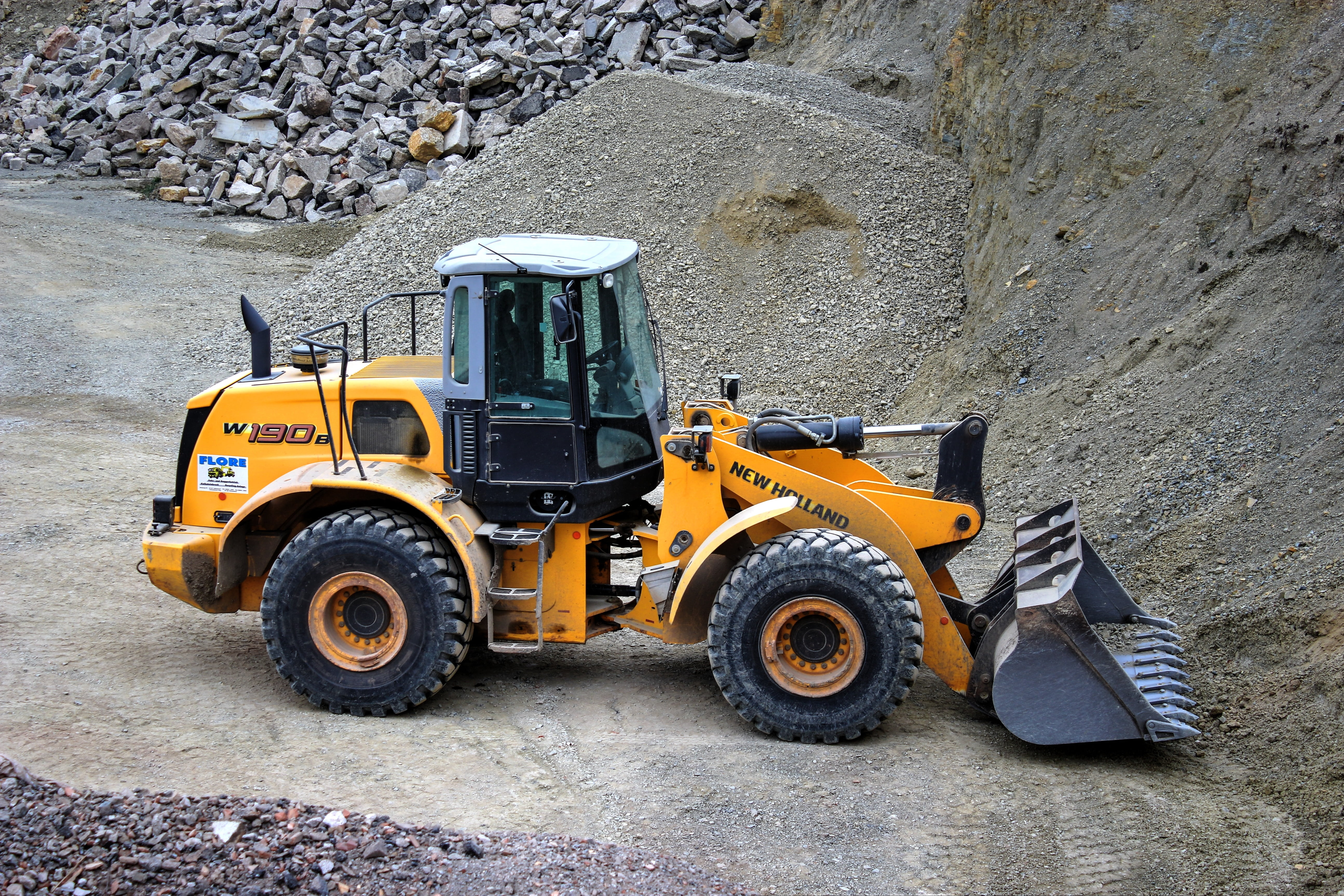 earth mover, construction equipment, holland, new holland, mode of transportation, land vehicle, commercial land vehicle, rock, working, stones, industry, HD Wallpaper
