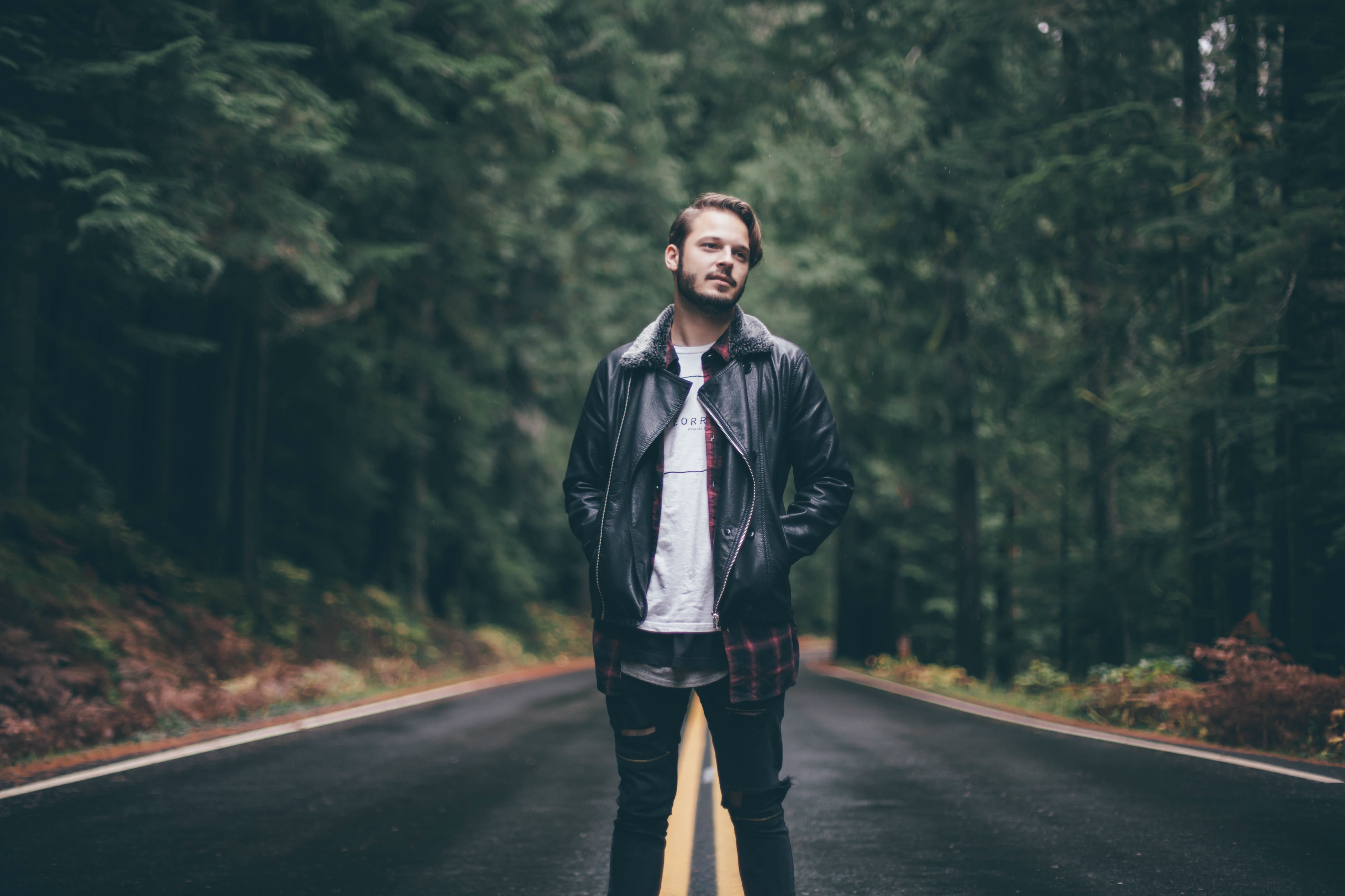 front view, young, model, middle, attractive, cool, one man only, forest, leather, pinetrees, trees, black leather jacket, tarmac, highway, tree trunks, HD Wallpaper