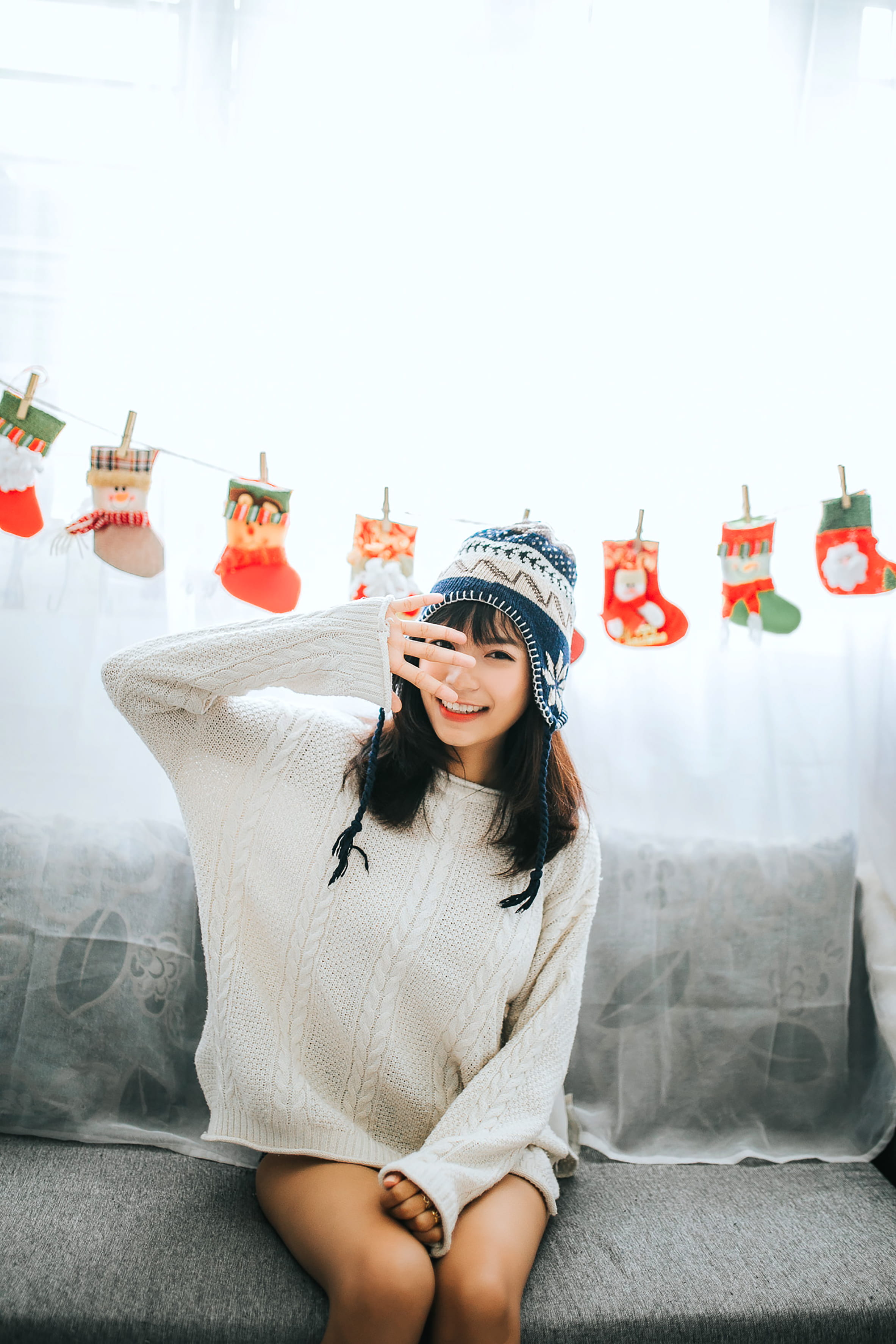 portrait, lifestyles, female, wearing, christmas, sofa, near, face, leisure activity, sitting, looking at camera, stockings, woman, one person, front view, Phone HD Wallpaper