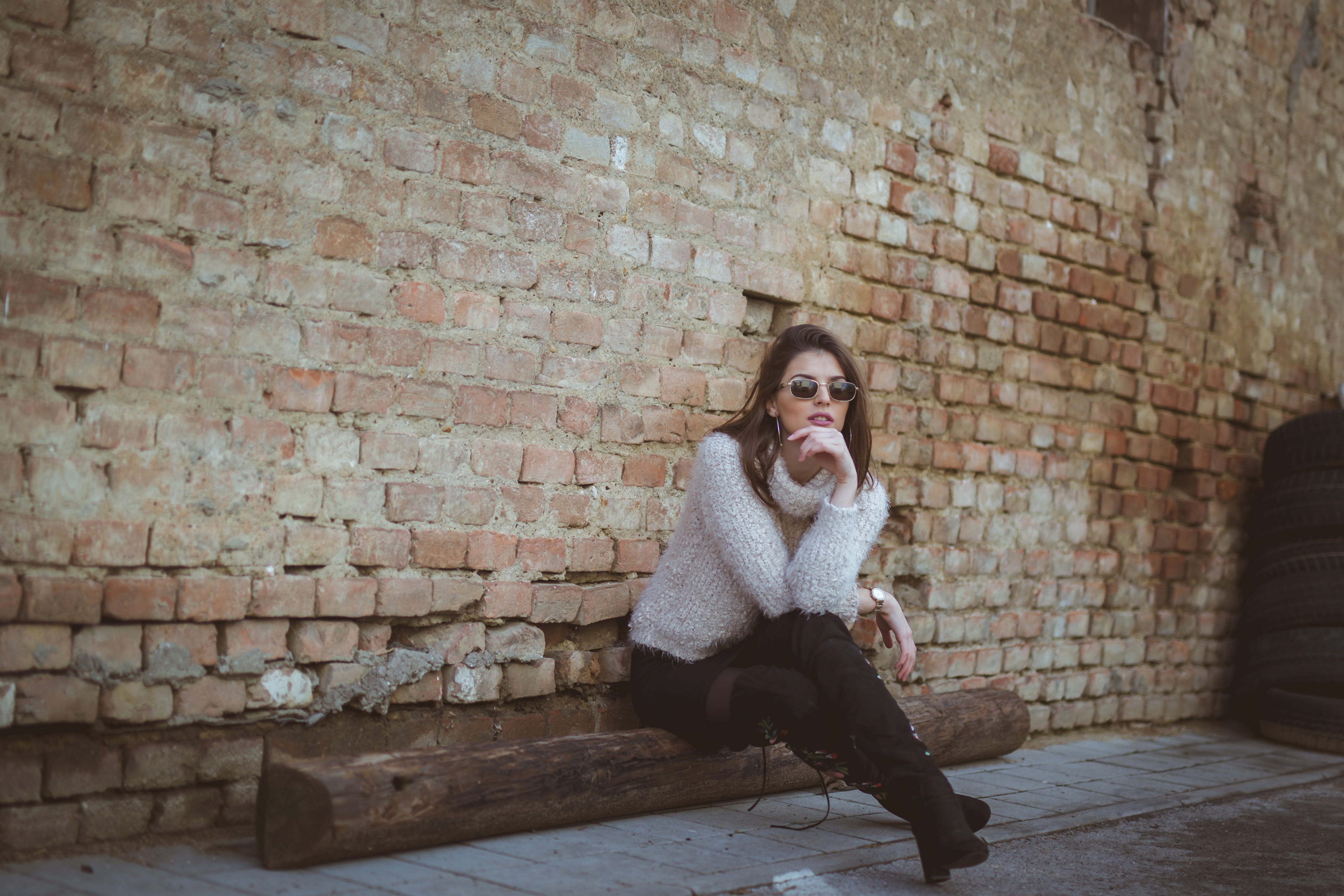 real people, sitting, apparel, sunglasses, front view, young adult, face, wall, casual clothing, leisure activity, girl, contemplation, warm clothing, full length, HD Wallpaper