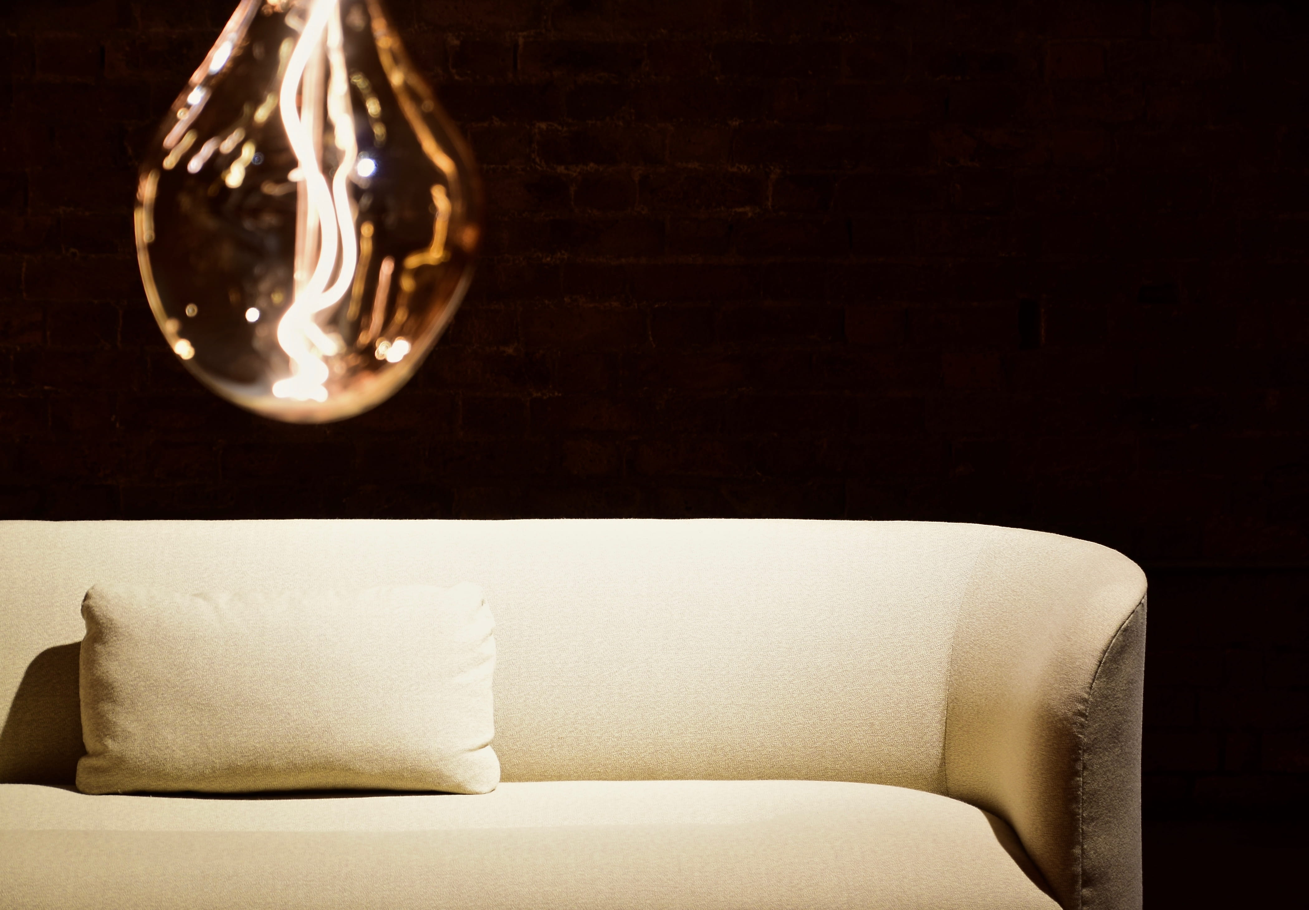 sofa, minimalism, no people, simplicity, light - natural phenomenon, furniture, indoors, table, still life, comfortable, wood - material, brick wall, home showcase interior, HD Wallpaper