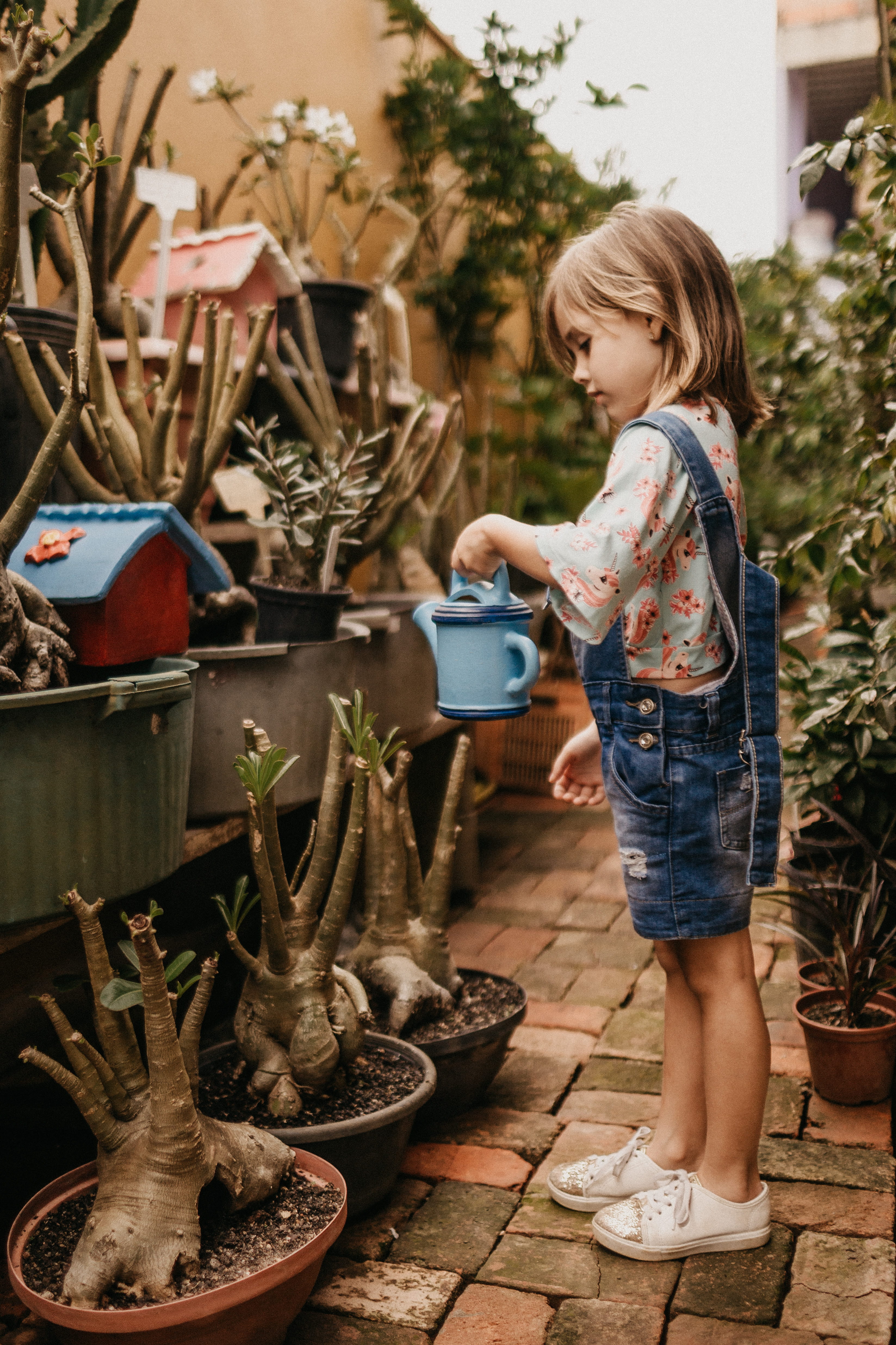 blond hair, girl, person, child, floricultura, hair, pants, hairstyle, leisure activity, garden, plant, full length, blue, casual clothing, camille, teal, Phone HD Wallpaper