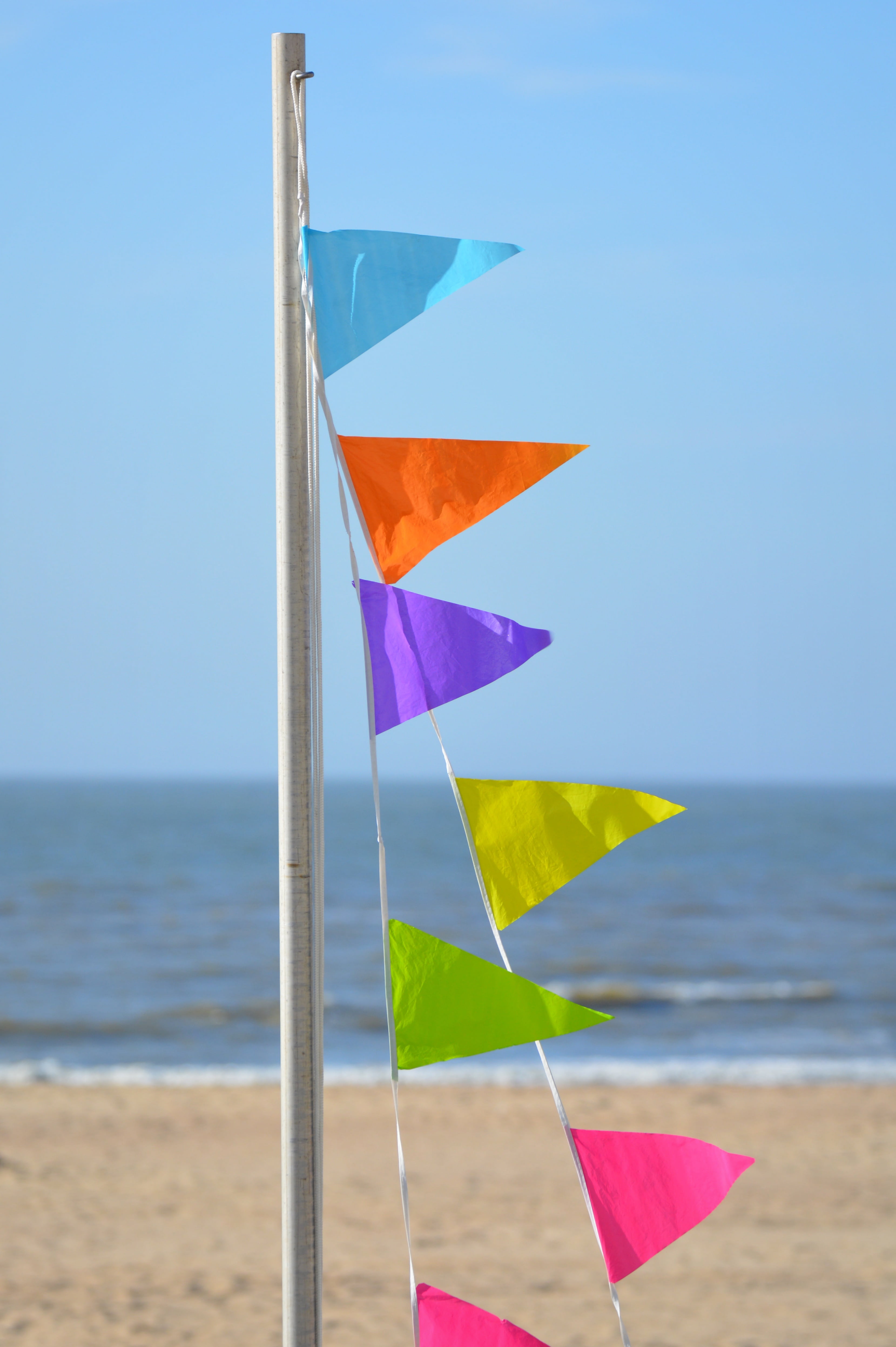 flag, focus on foreground, horizon over water, wind, scenics - nature, pennants, horizon, multi colored, nature, flags, land, clear sky, summer, blue sky, Phone HD Wallpaper