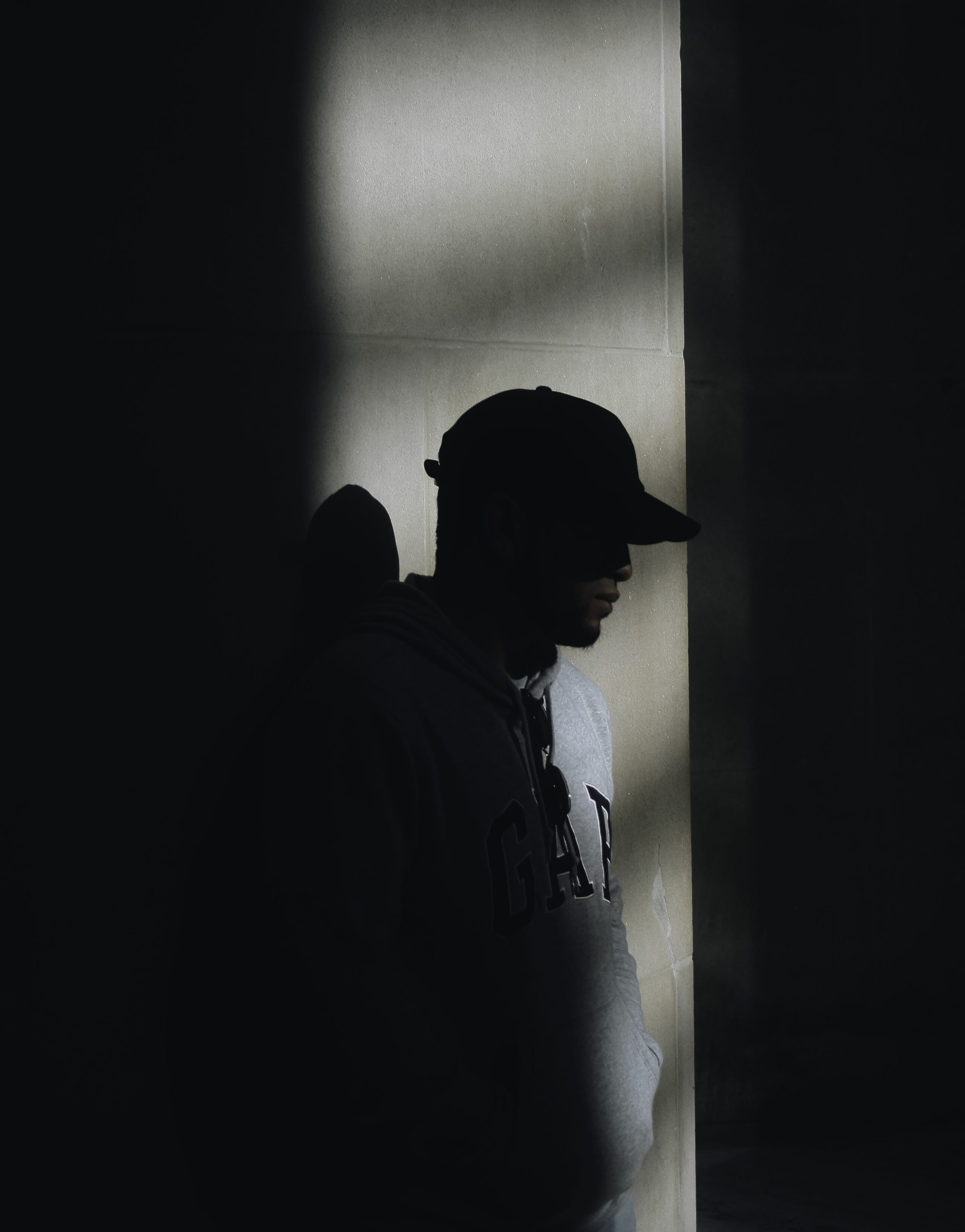 wall - building feature, depression - sadness, adult, photo, looking away, street wear, indoors, leaning, wearing, door, portrait, built structure, real people, Phone HD Wallpaper