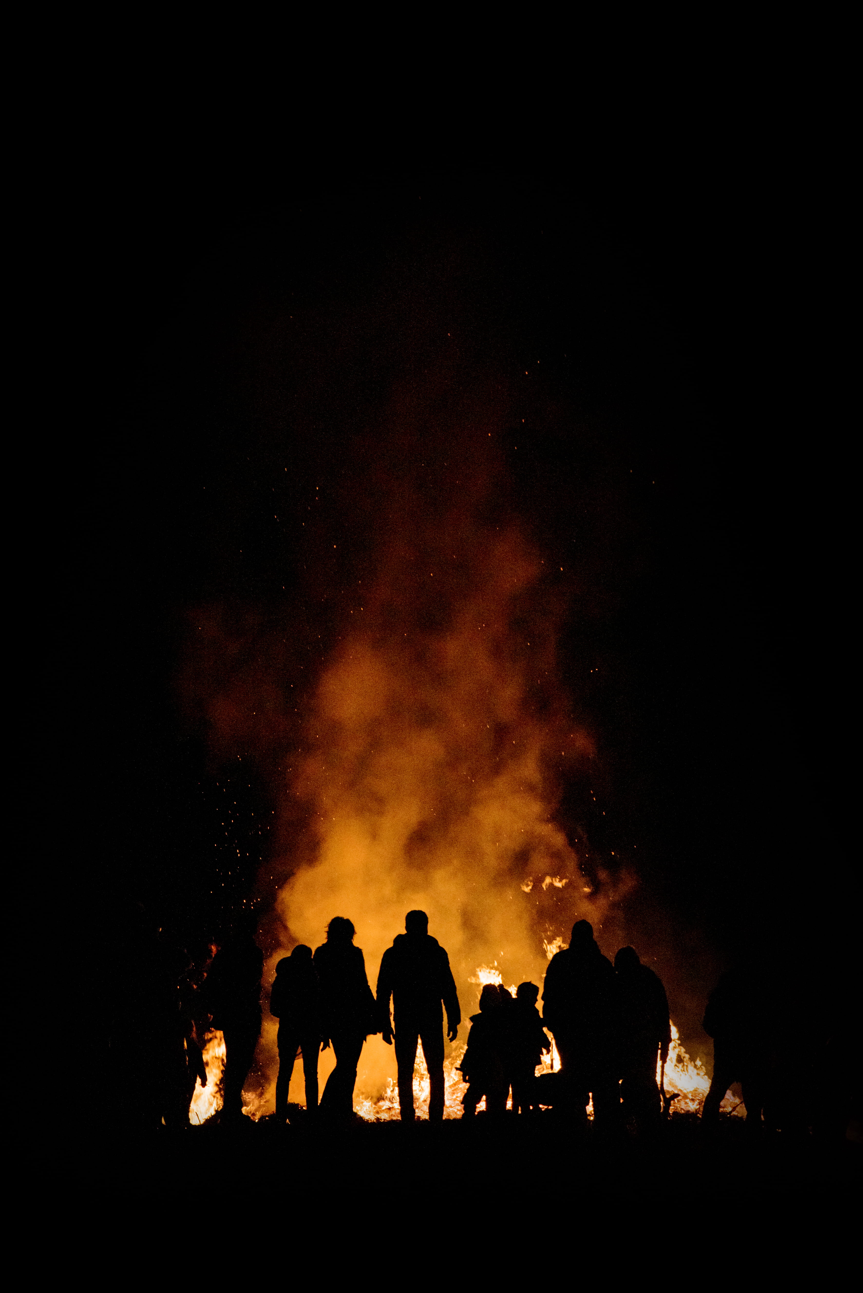 crowd, orange, surrounded, flame, red, bonfire, action, group, black Color, night, yellow, outdoors, campfire, person, fire, silhouette, burning, alessio soggetti, Phone HD Wallpaper