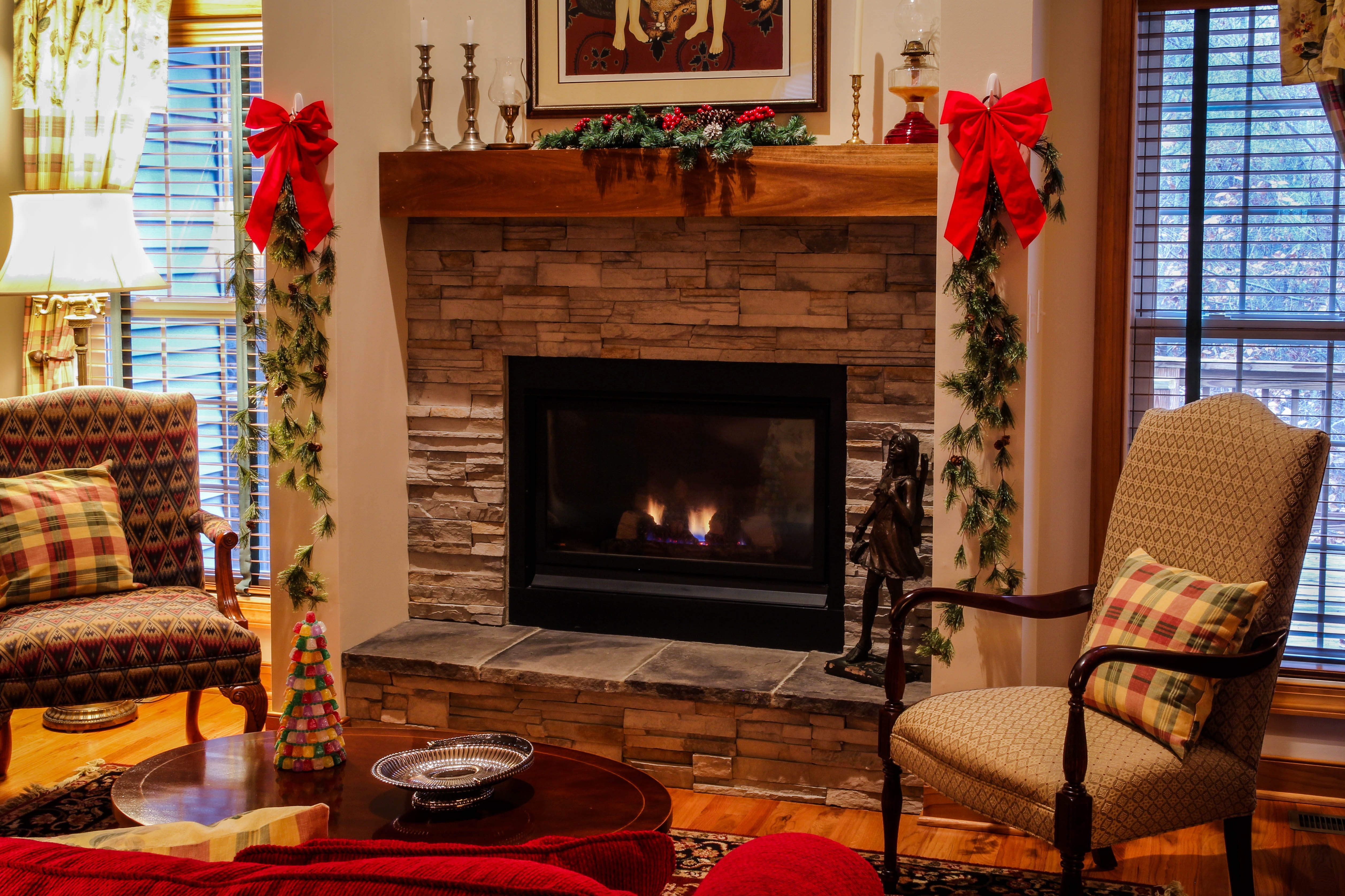 stone fireplace, table, fireplace, armchair, burning, fire, furniture, chairs, hearth, comfortable, home interior, gas fireplace, christmas, seat, pine garland, HD Wallpaper