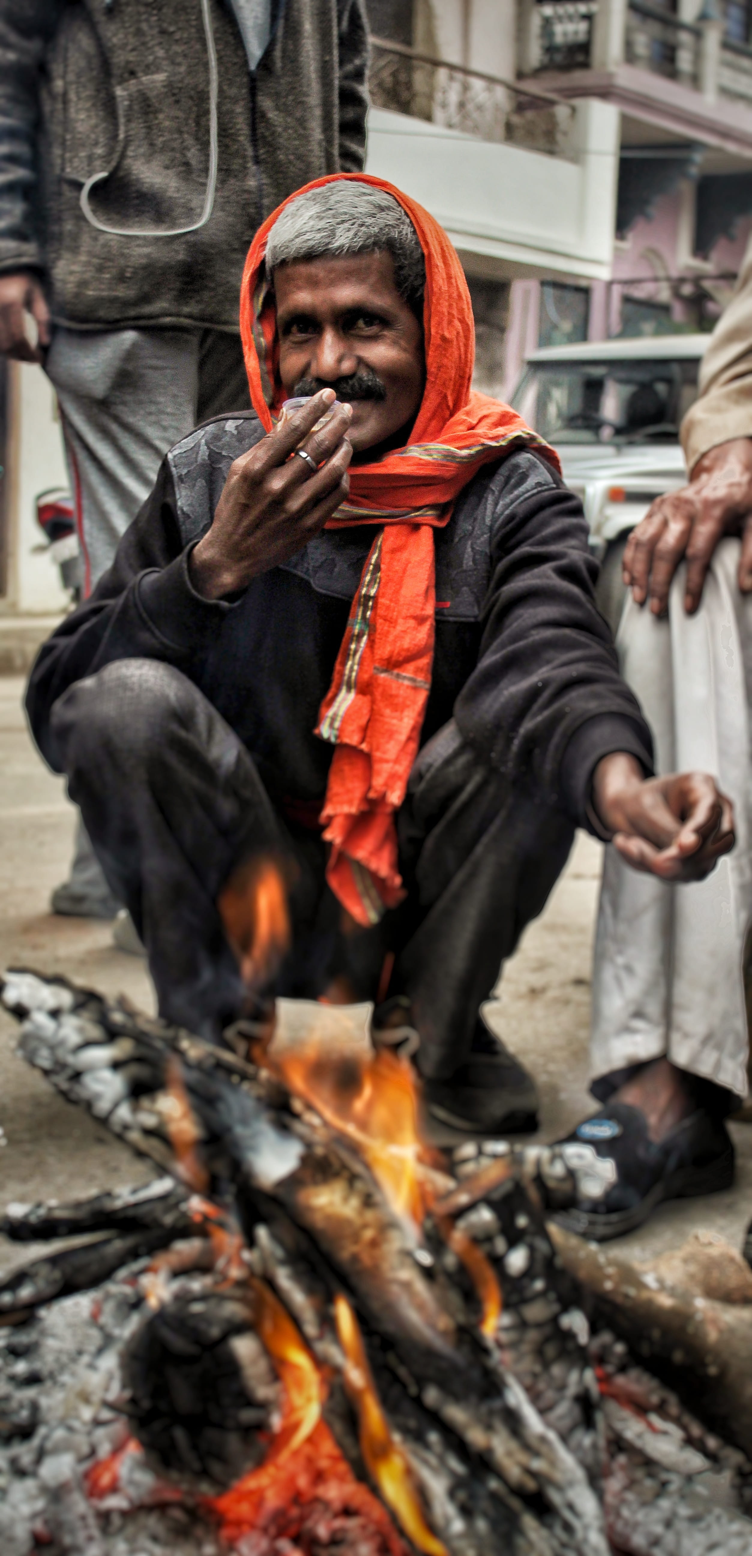 smoke, potrait, real people, sitting, india, fire - natural phenomenon, looking at camera, person, fire, lifestyles, waist up, apparel, finger, shoe, heat - temperature, Phone HD Wallpaper