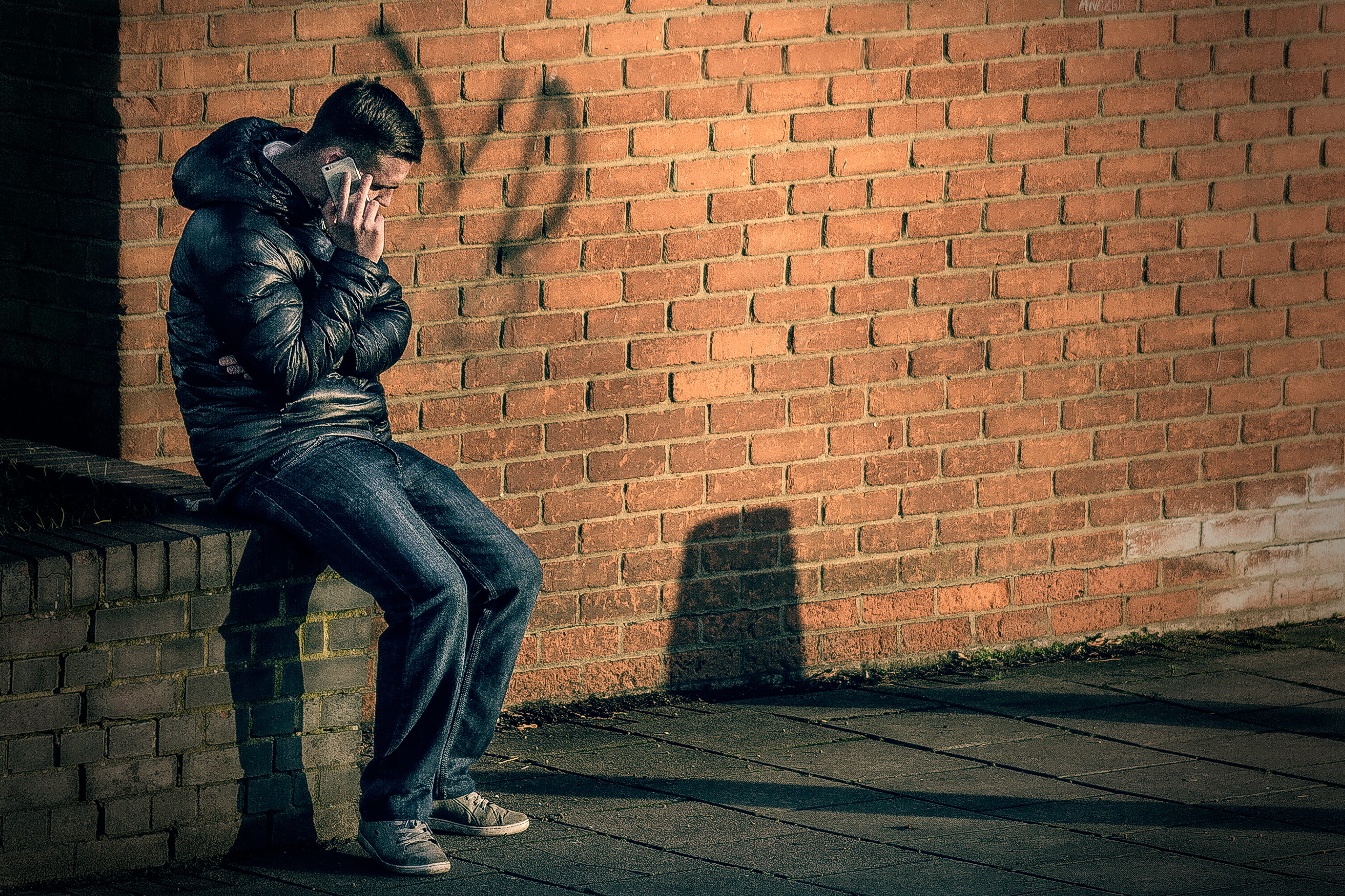 sitting, representation, black, smartphone, building, full length, jacket, street, man, no people, human representation, 5K, outdoors, person, holding, HD Wallpaper
