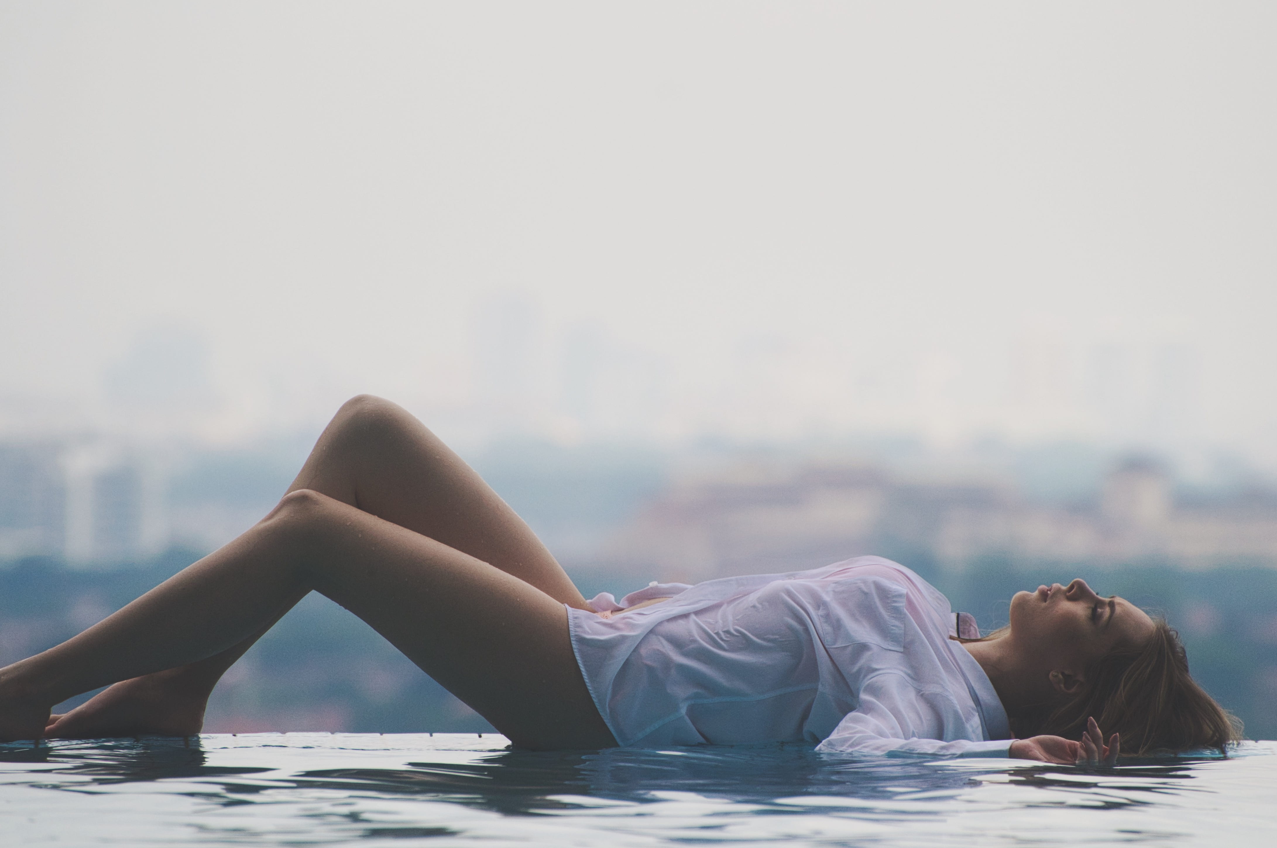 beautiful woman, style, lying, hairstyle, city, shirt, women, beauty, side, lying down, nature, daytime, background, leisure activity, lazing, pool, swimming pool, HD Wallpaper