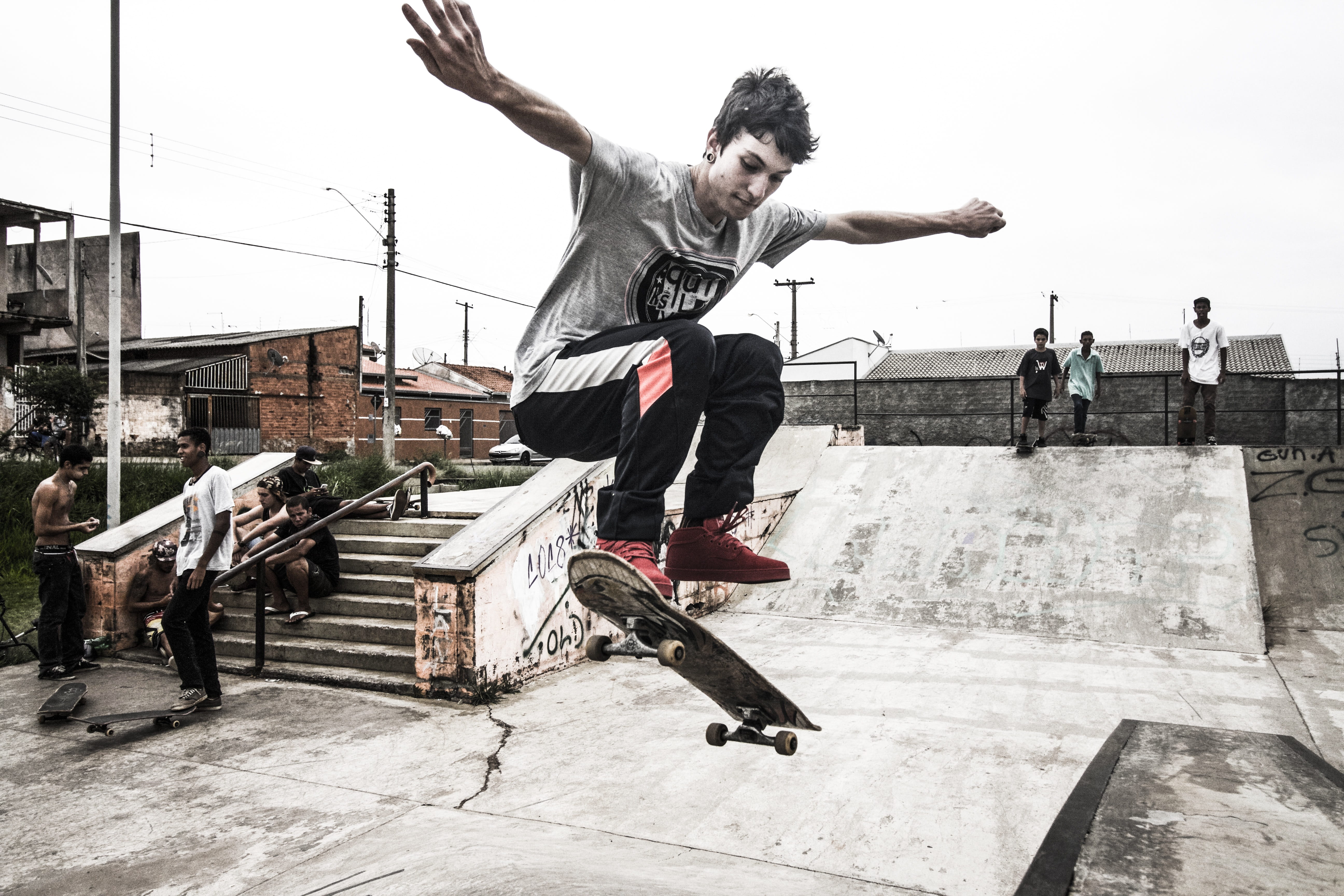 building exterior, jumping, motion, skateboard trick, limb, outdoors, city, skater, one person, man in gray, teenager, leisure activity, extreme sport, HD Wallpaper
