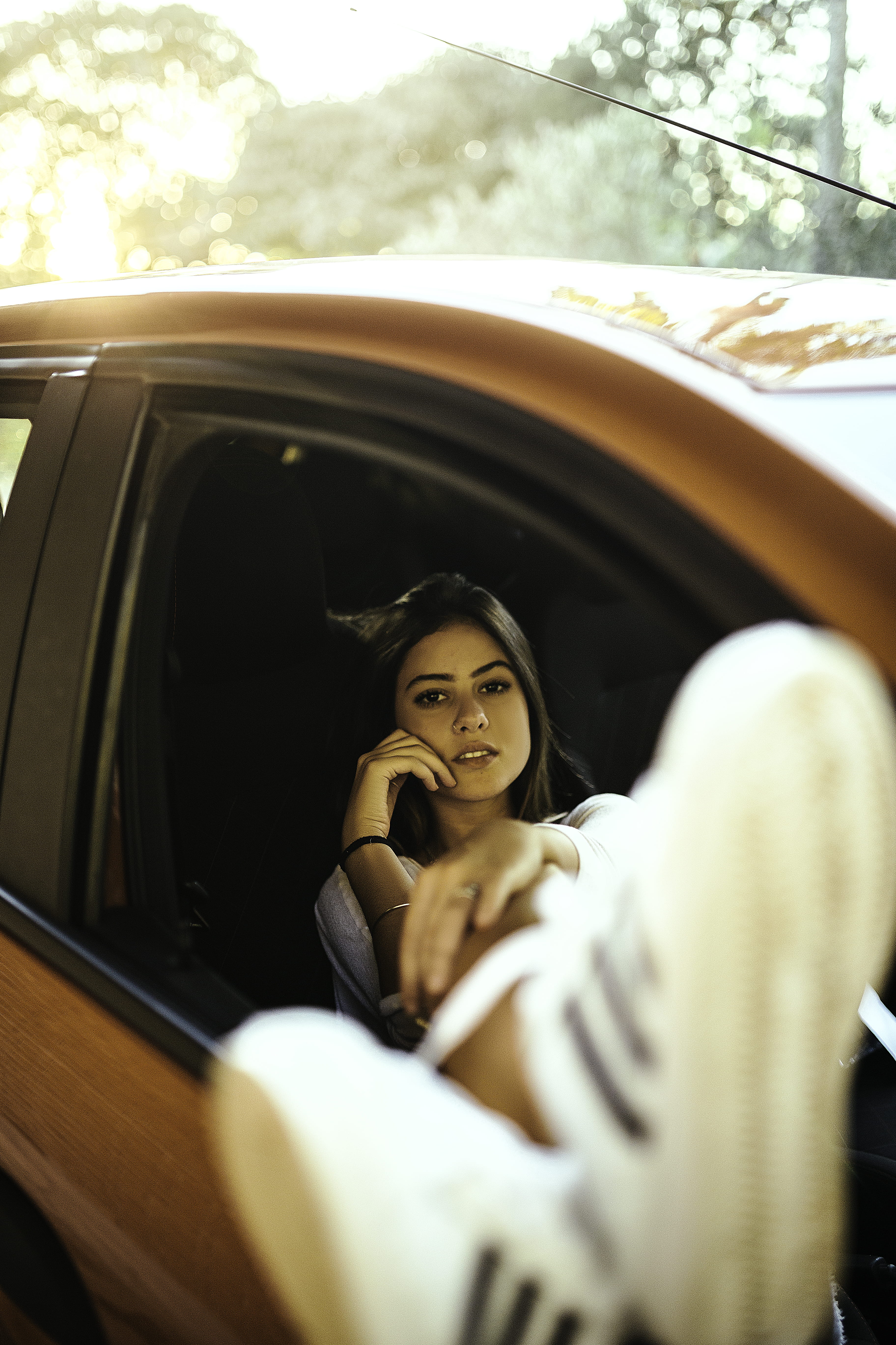smiling, sitting, 5K, one person, motor vehicle, driver, transportation system, looking at camera, young adult, car interior, relaxation, driving, portrait, Phone HD Wallpaper
