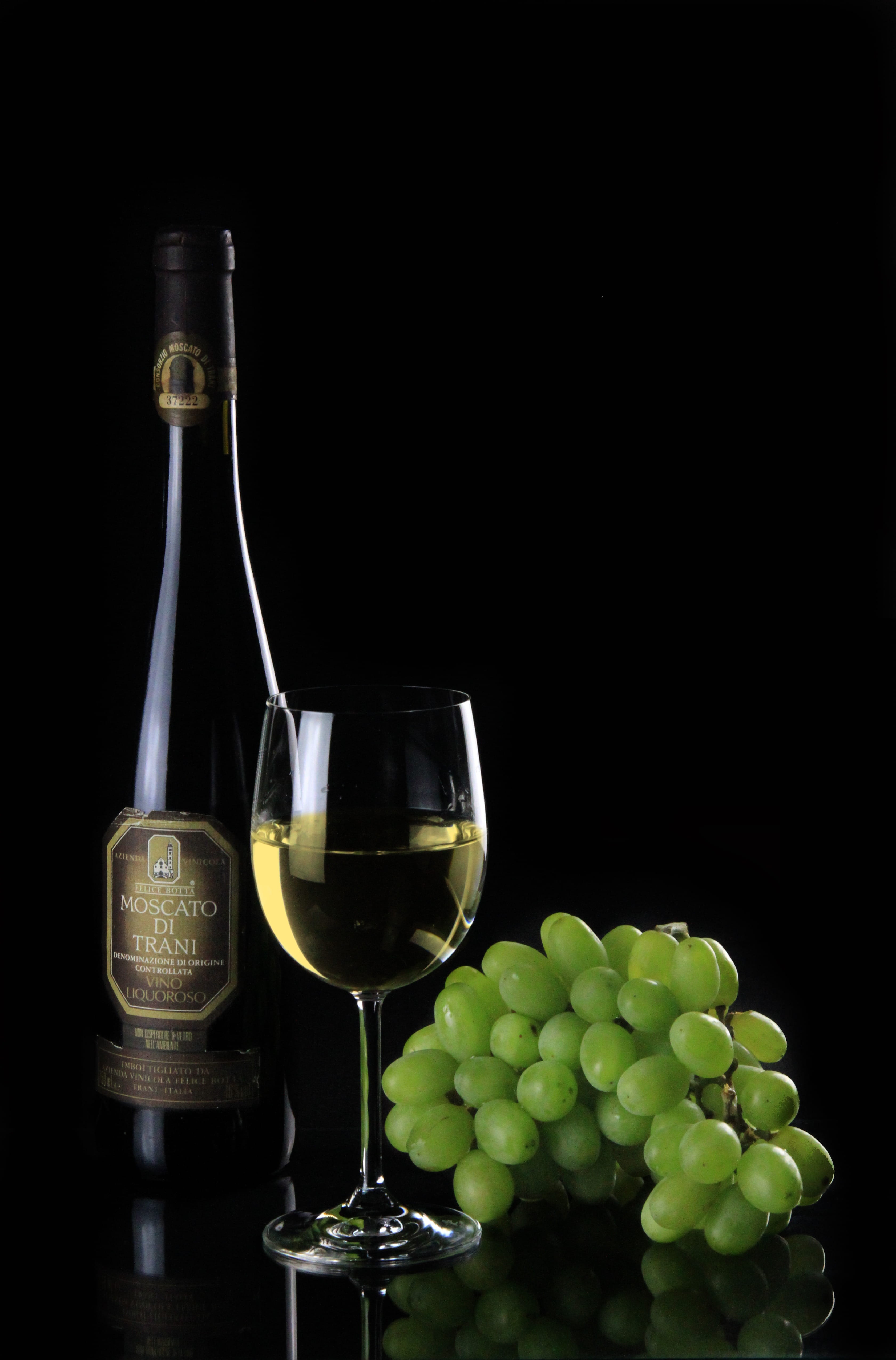 no people, dark, glass, black background, refreshment, glass - material, label, still life, bottle, grapes, Di Trani, green, drinking glass, household equipment, Phone HD Wallpaper