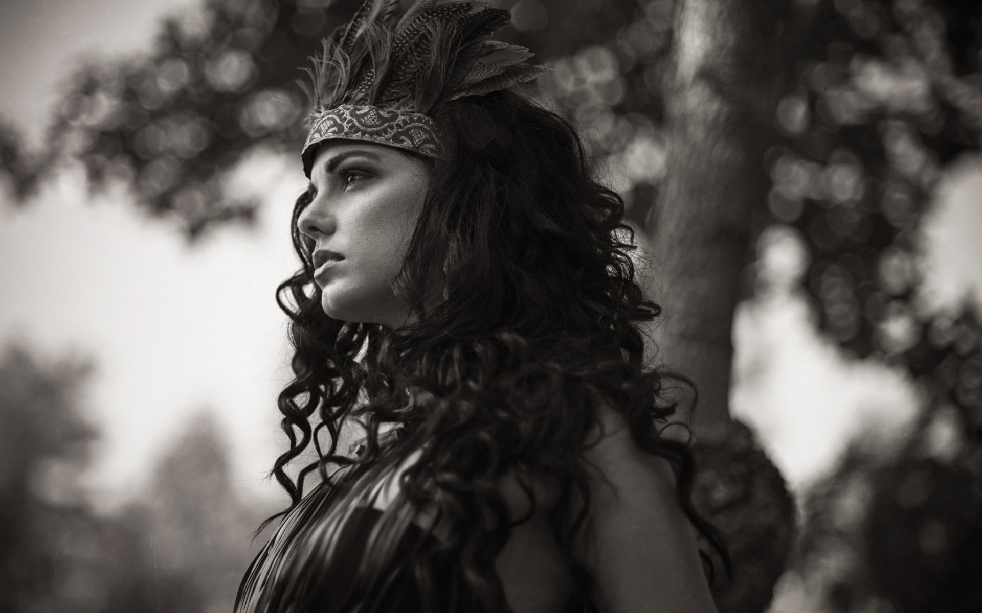 head band, women, trees, depth of field, nature, 1080P, women outdoors, profile, long hair, face, bokeh, model, brunette, feathers, curly hair, monochrome, HD Wallpaper