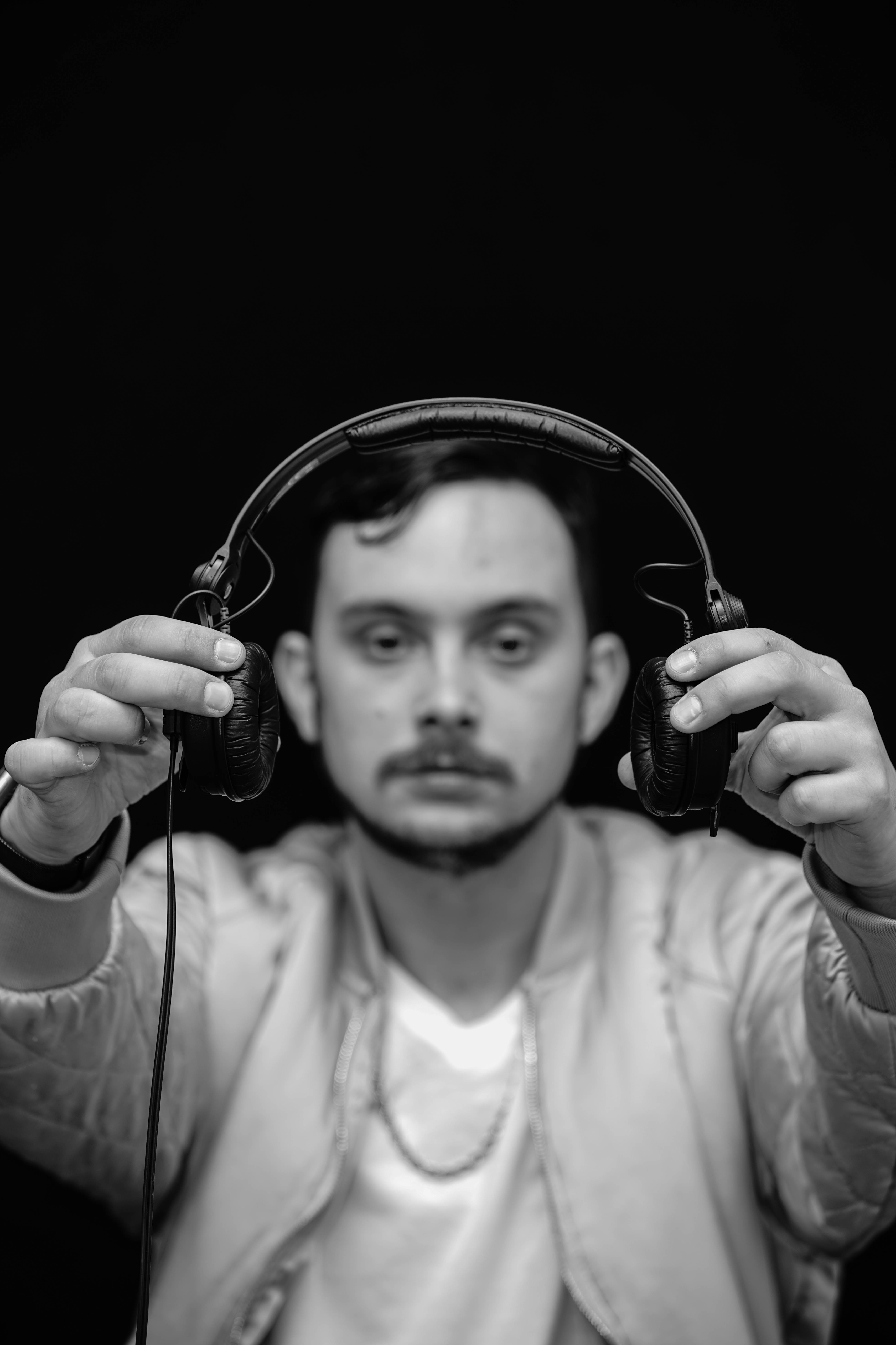 holding, portrait, portraiture, men, one person, dance, black background, monochrome, 8K, studio, headphones, headshot, production, looking at camera, Phone HD Wallpaper