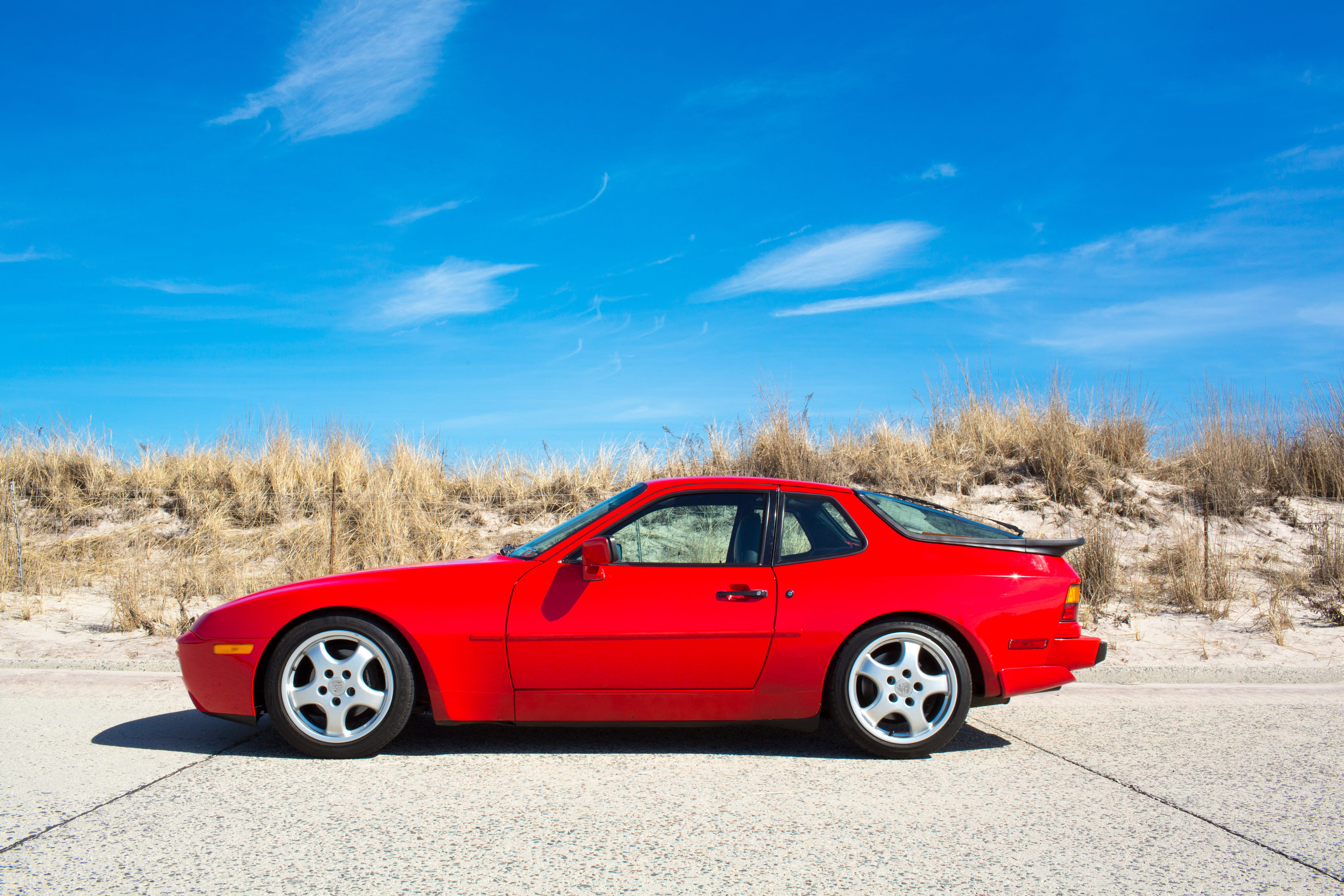 porsche, blue, race car, transportation, babylon, sports car, sunlight, road, day, land, mode of transportation, 5K, nature, beach, outdoors, field, red, HD Wallpaper