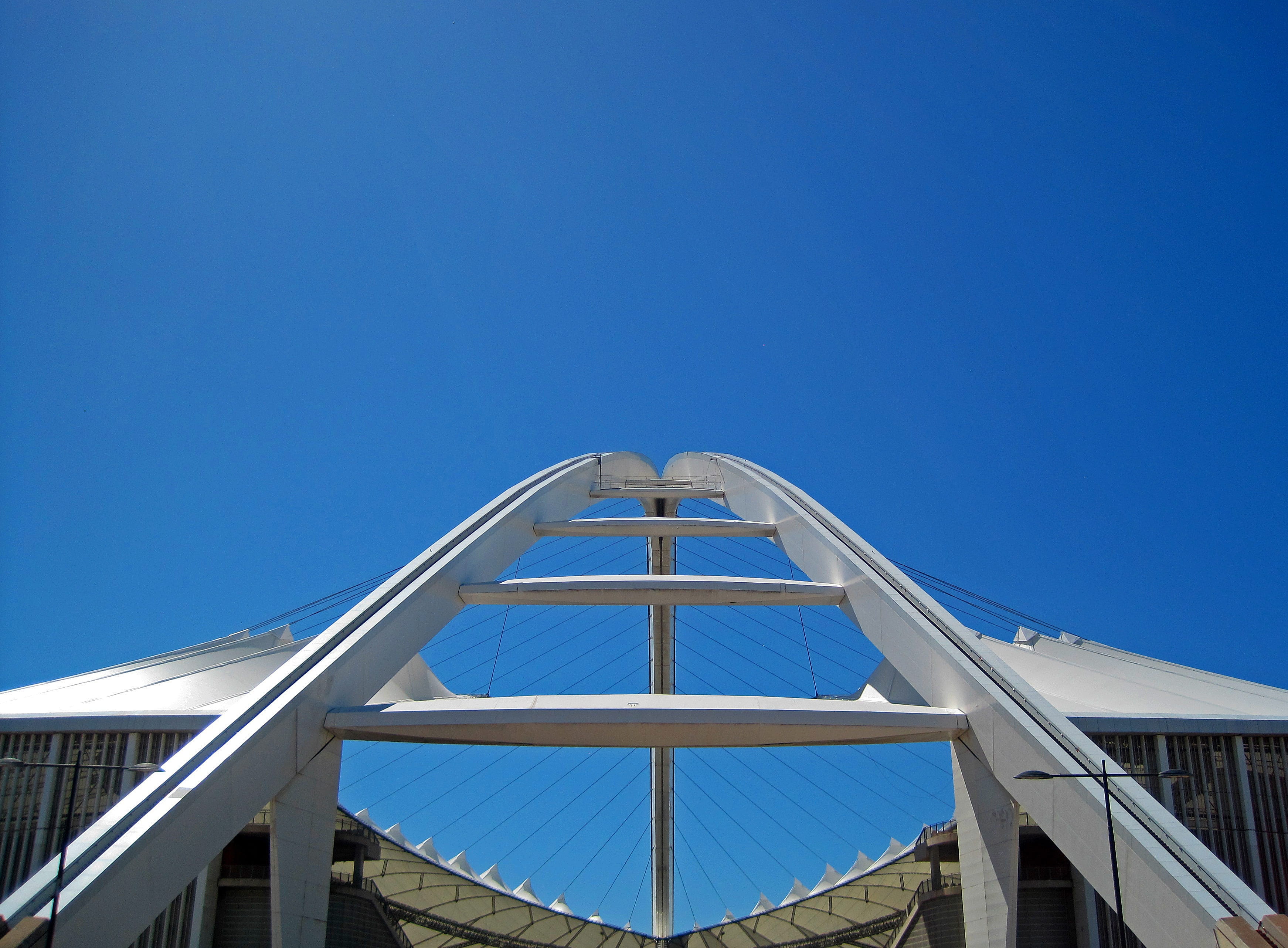 stadium, side view, no people, nature, sunny, blue, clear sky, copy space, grid, building exterior, bridge, outdoors, sky, glass, day, directly below, roof, HD Wallpaper