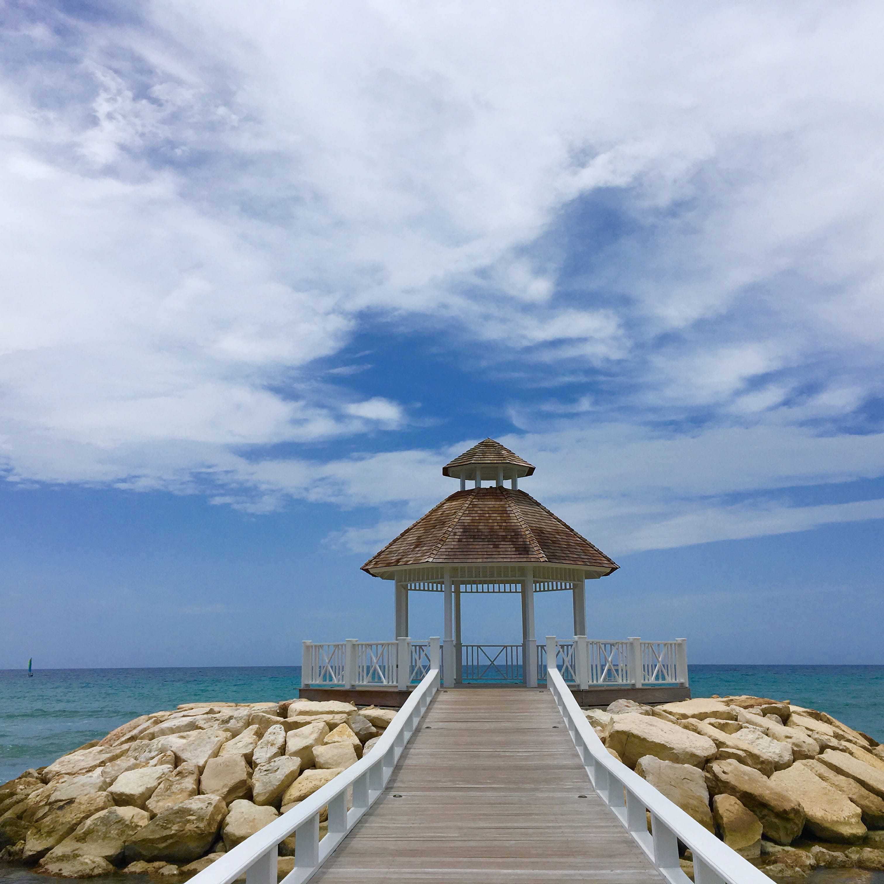 horizon over water, cloud - sky, nature, clouds, day, sea, rocks, tranquil scene, structure, saint james parish, the way forward, architecture, tropical, Phone HD Wallpaper