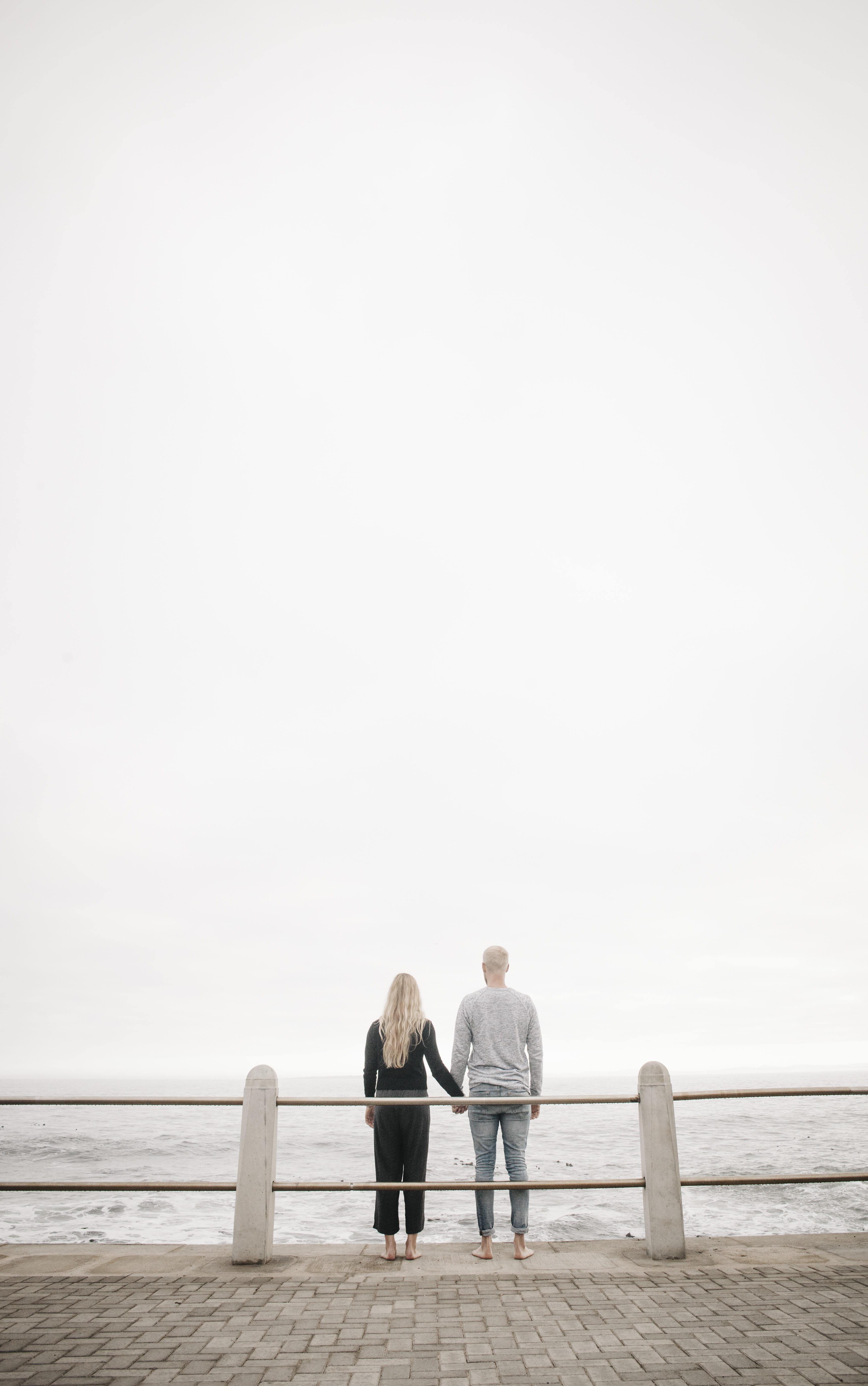 women, water, fence, senior men, sea side, outside, looking out, sidewalk, men, daytime, adult, expression, rear view, sky, blonde, holding hands, body, Phone HD Wallpaper
