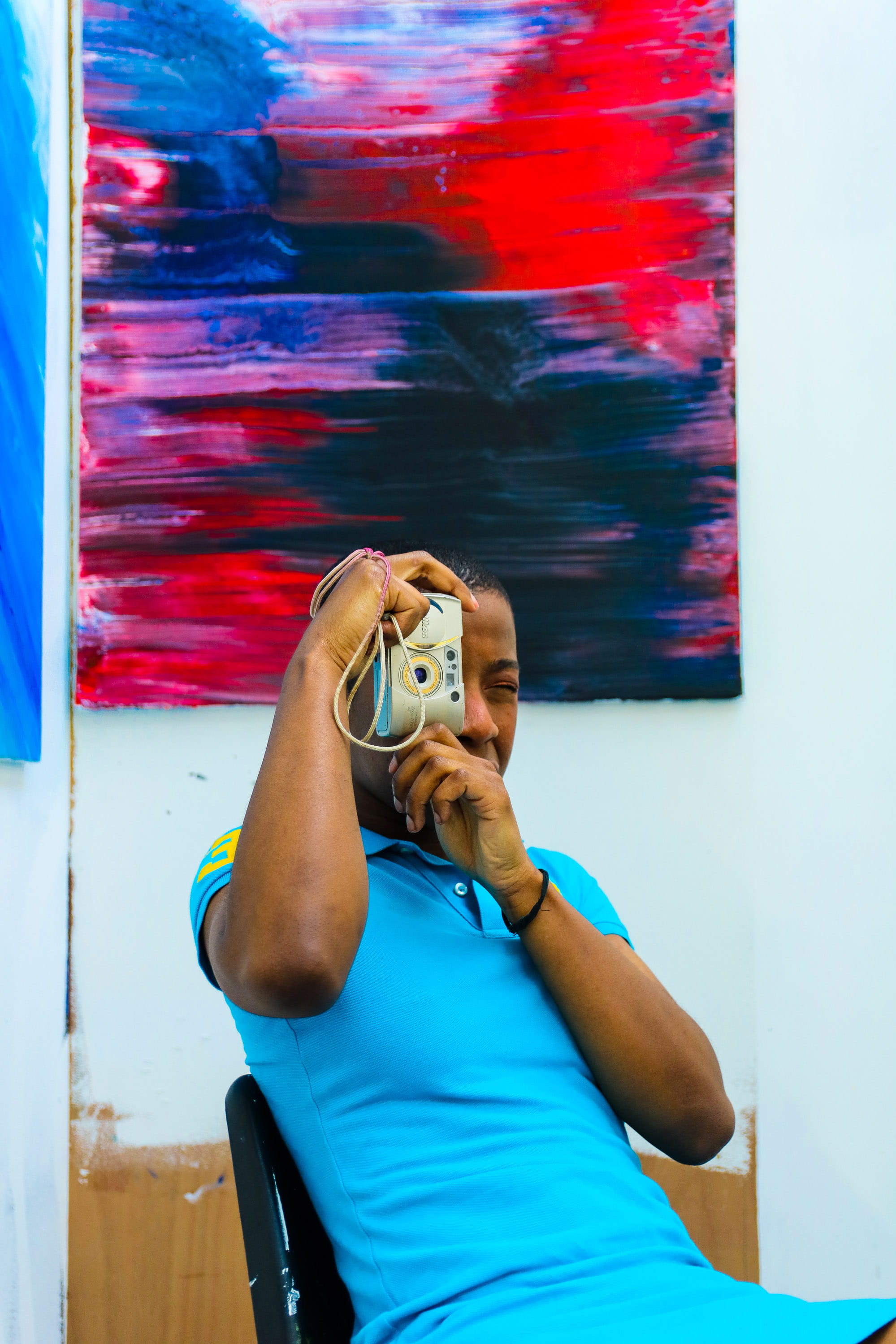 lady, 2K, sitting, day, taking photo, creativity, wall, close-up, colorful, black, photo, indoors, contemporary art, chair, young, artistic, design, fashionable, Phone HD Wallpaper