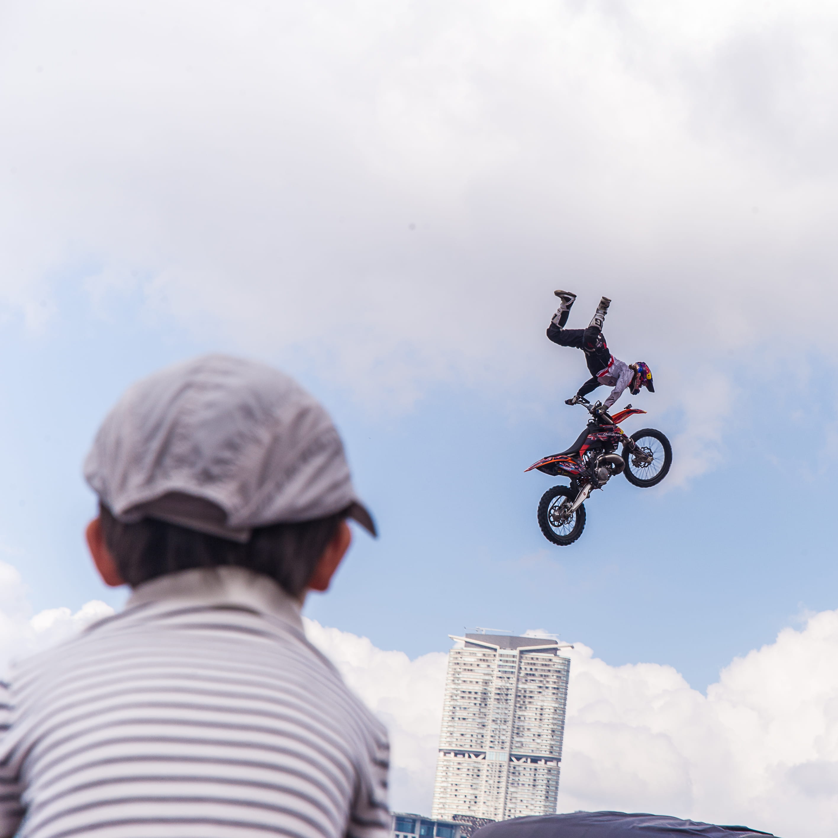 child, sky, people, land vehicle, lifestyles, mid-air, outdoors, skill, cloud - sky, men, leisure activity, redbull, crash helmet, headwear, real people, Phone HD Wallpaper