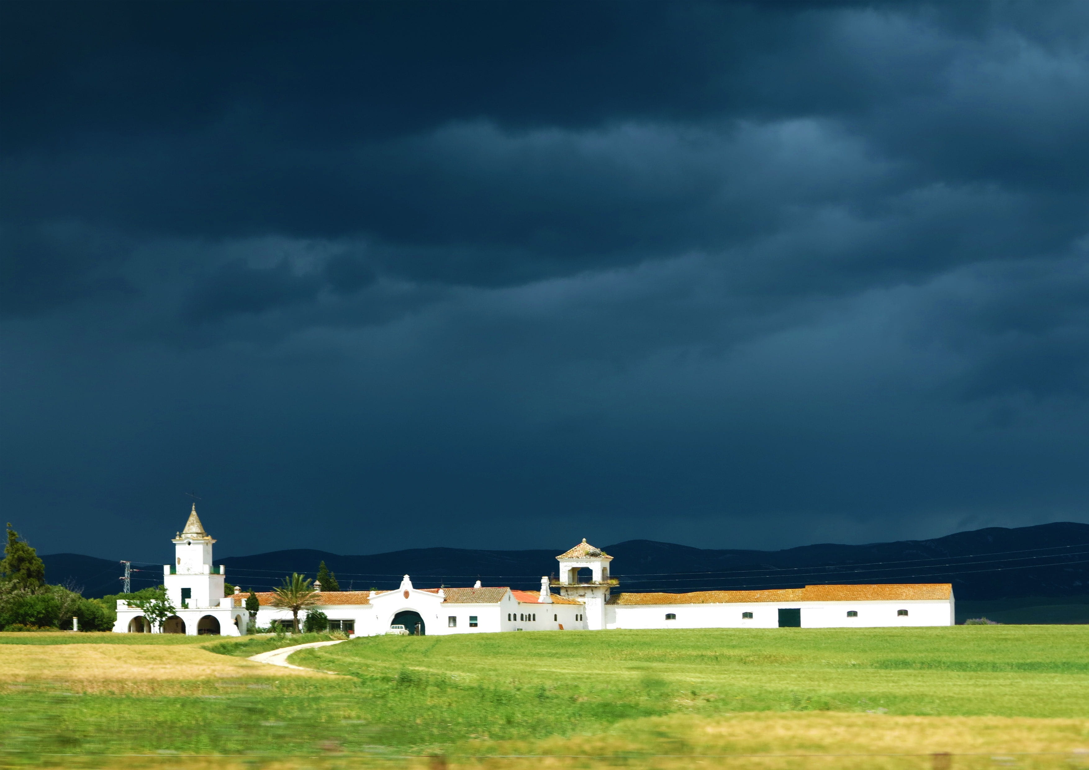 Spain, storm cloud, rain clouds, outdoors, religion, House, grass, building, ominous, storm, built structure, architecture, 2K, plant, belief, sky, nature, HD Wallpaper