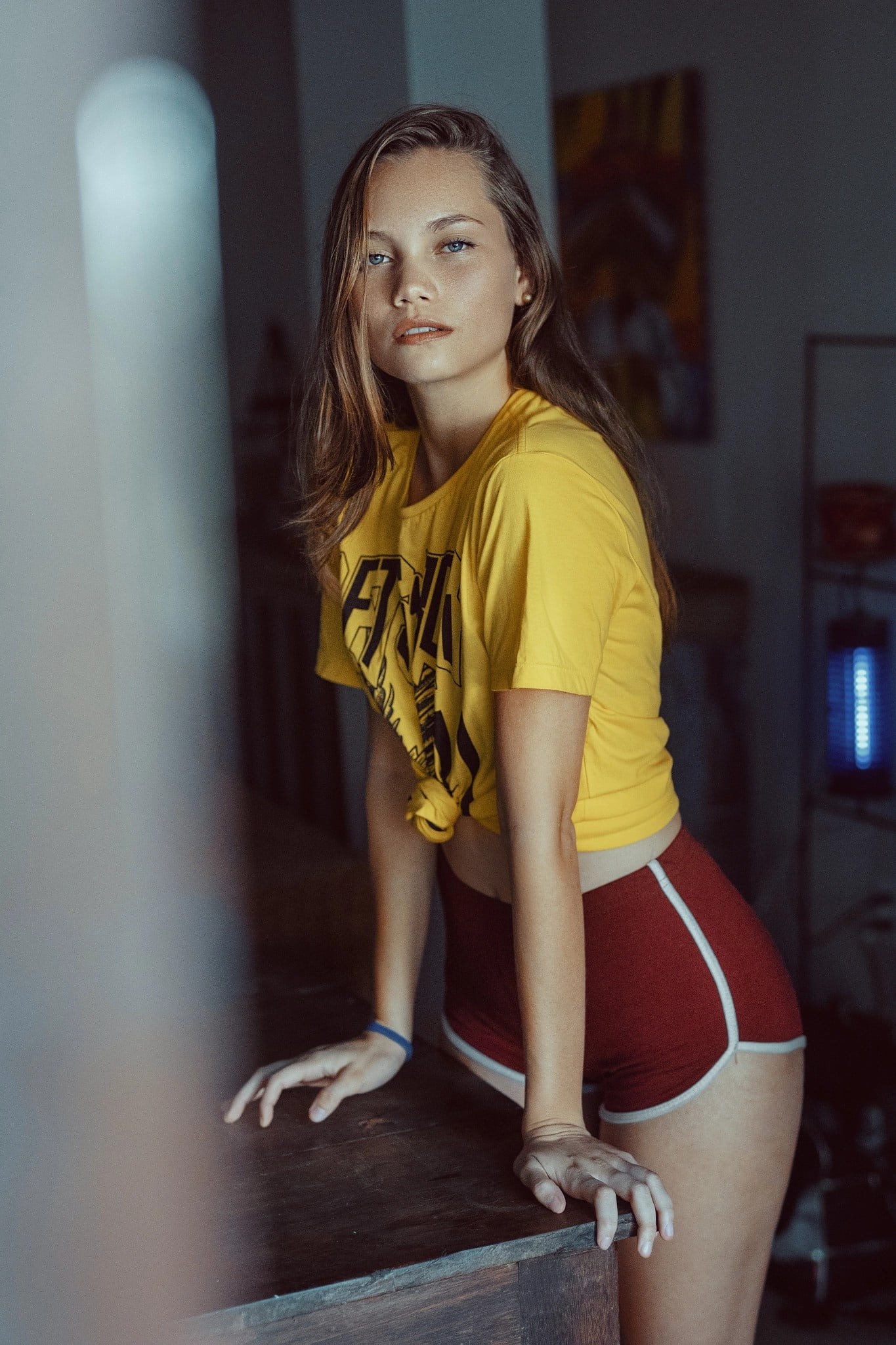 bokeh, blue eyes, 1080P, high waisted short, depth of field, Thiago Bomfim, looking at viewer, shirt, short shorts, women, brunette, women indoors, Latinas, Phone HD Wallpaper