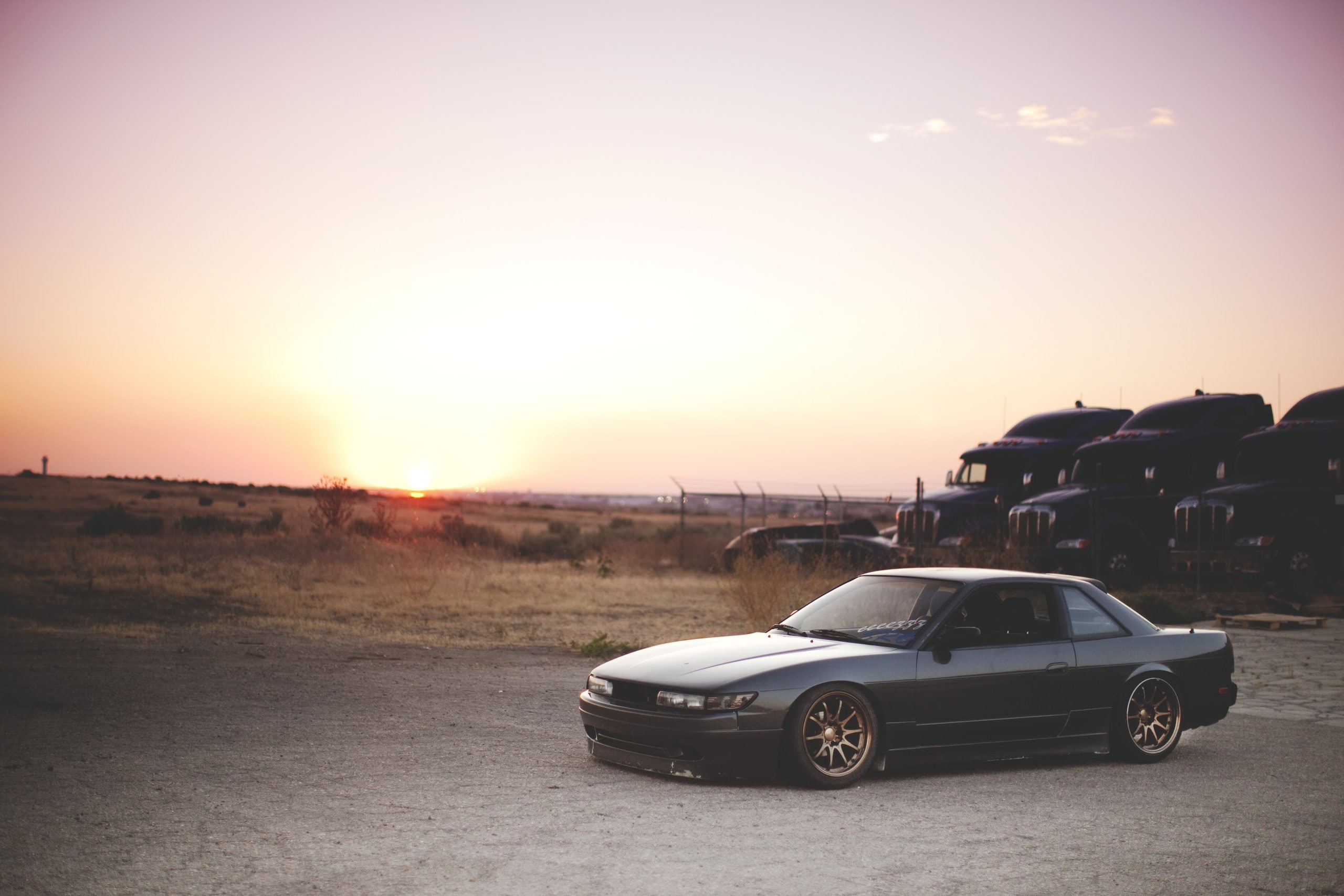 stationary, sunset, sunlight, land vehicle, land, coupe, no people, environment, landscape, transportation, 2K, nature, motor vehicle, black, car, road, HD Wallpaper