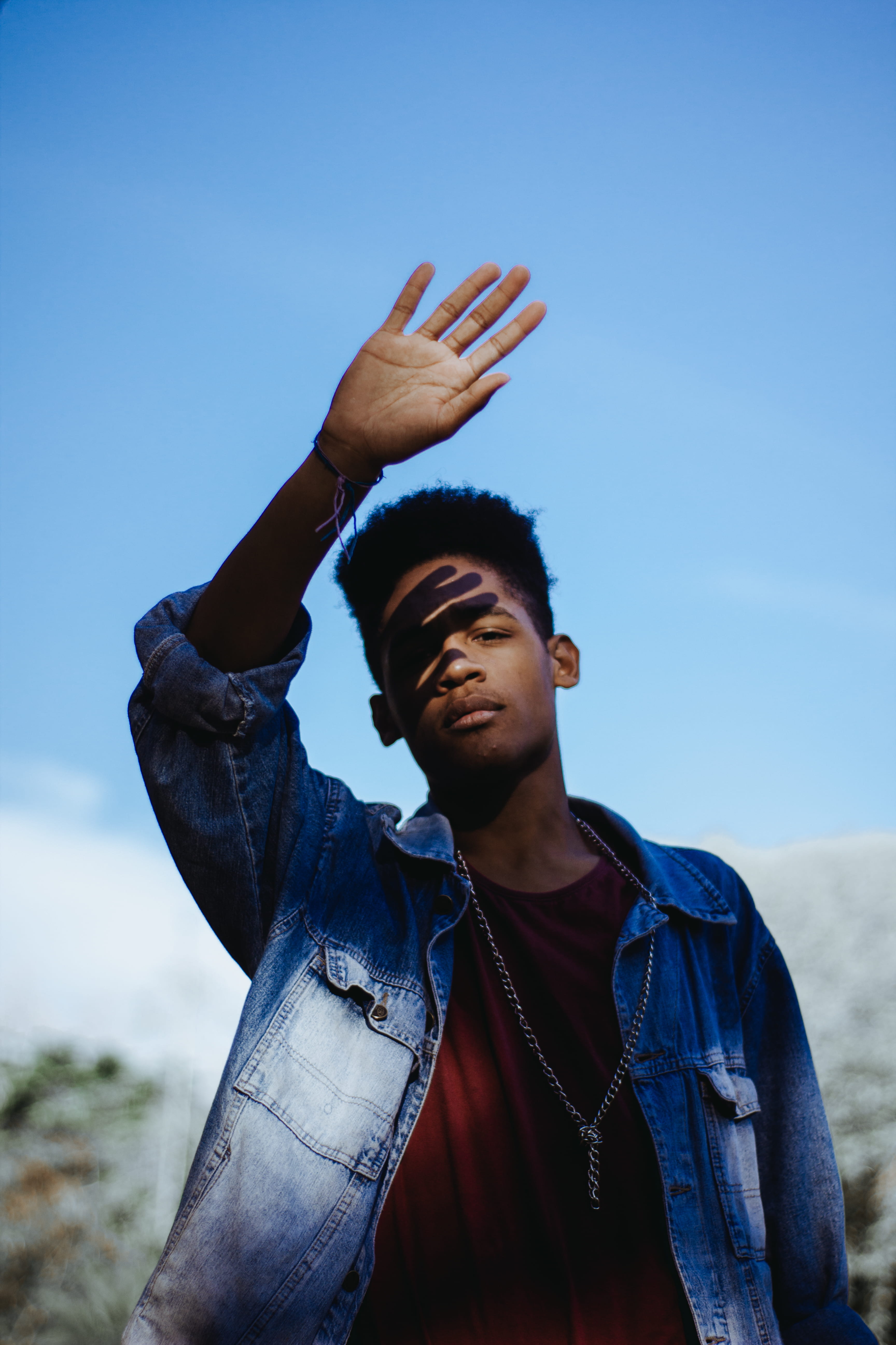 right, one person, waist up, necklace, denim, raising, covering, 5K, eye, casual clothing, man, outdoors, light, lifestyles, sky, rays, young adult, young men, Phone HD Wallpaper
