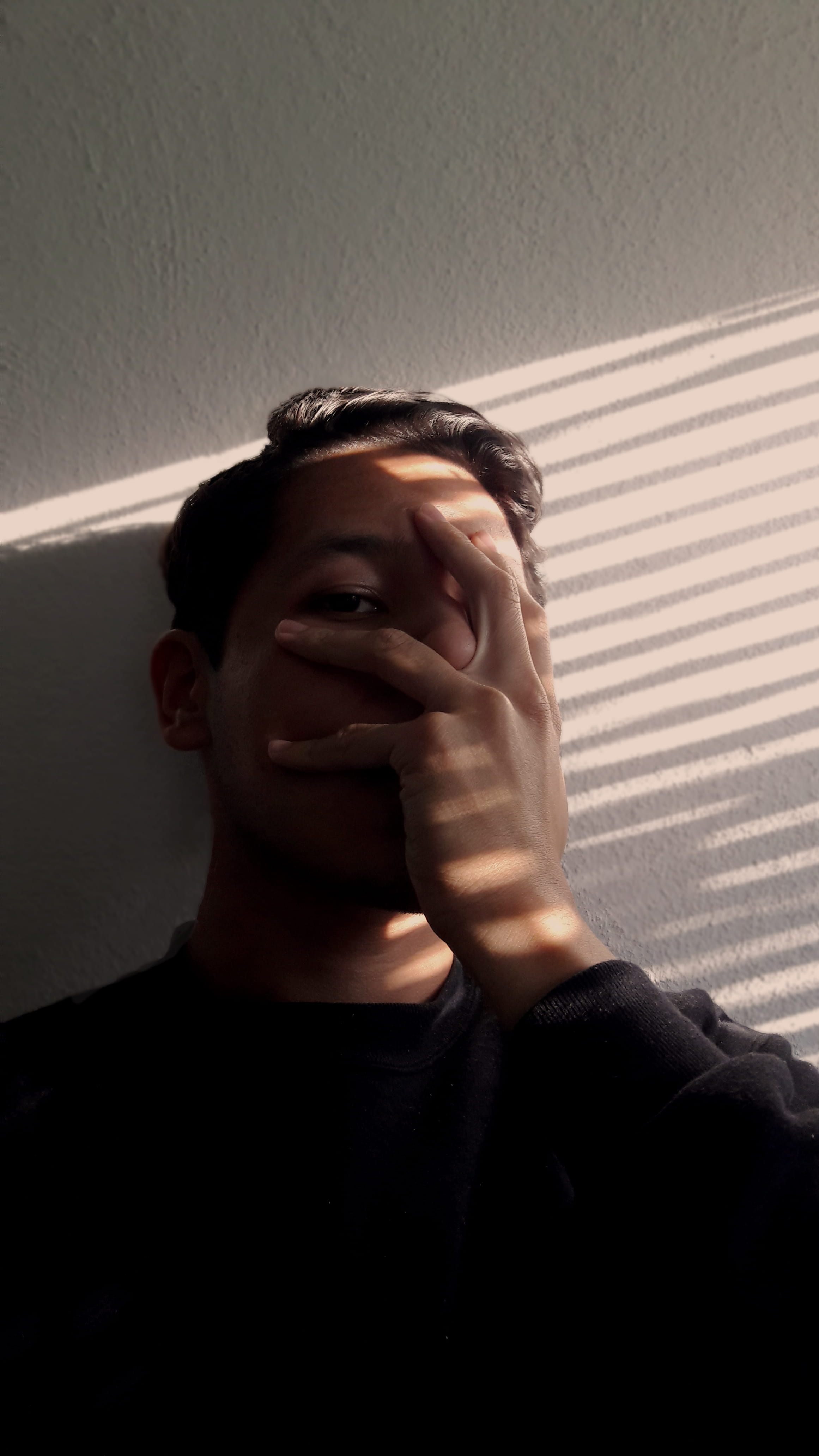 lifestyles, front view, hands, sunlight, young men, thoughts, looking, face, dark, contemplation, portrait, men, depression - sadness, day, home interior, Phone HD Wallpaper
