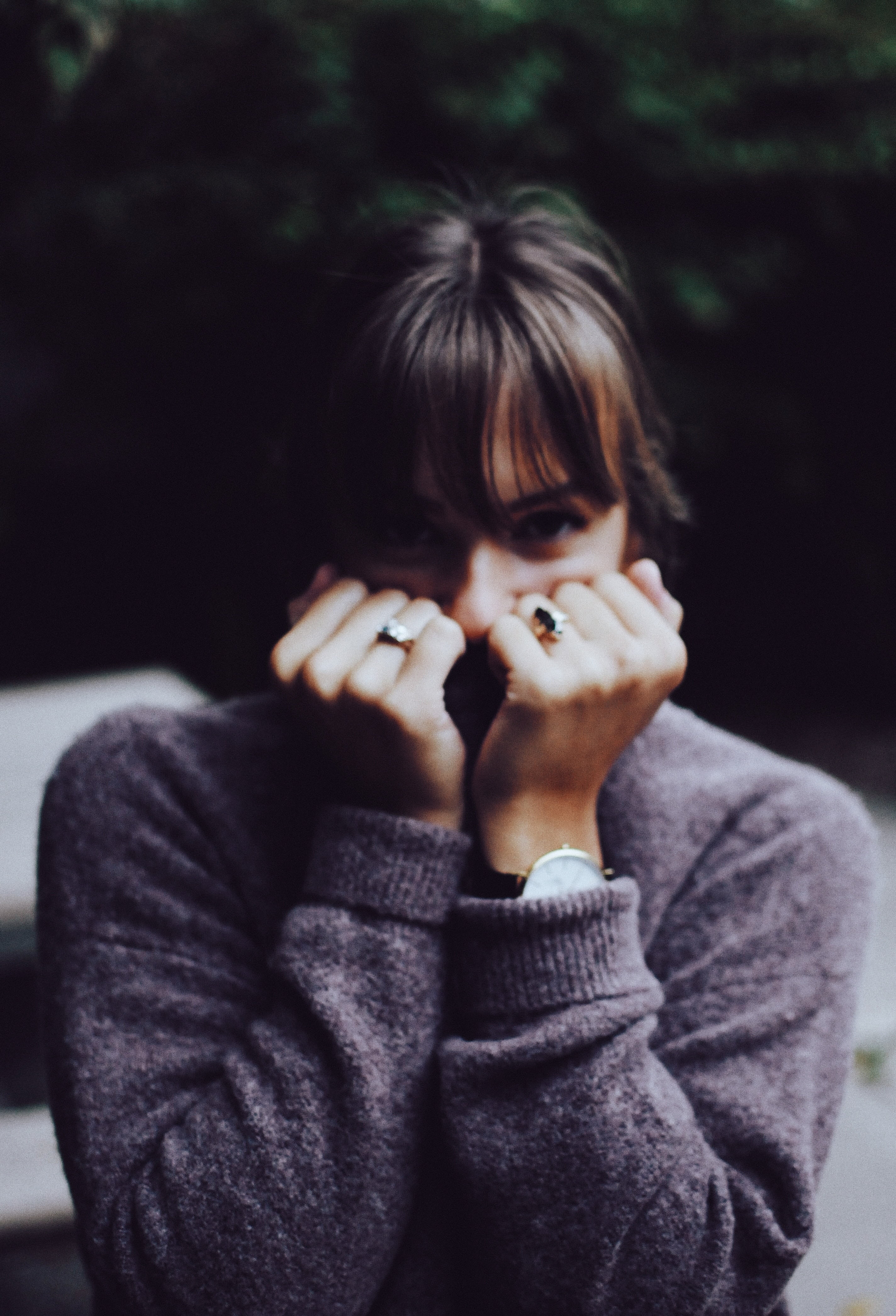 front view, sweater, one woman only, only women, headshot, woman, bangs, focus on foreground, childhood, finger, holding, hand, child, dark, close-up, human body part, Phone HD Wallpaper