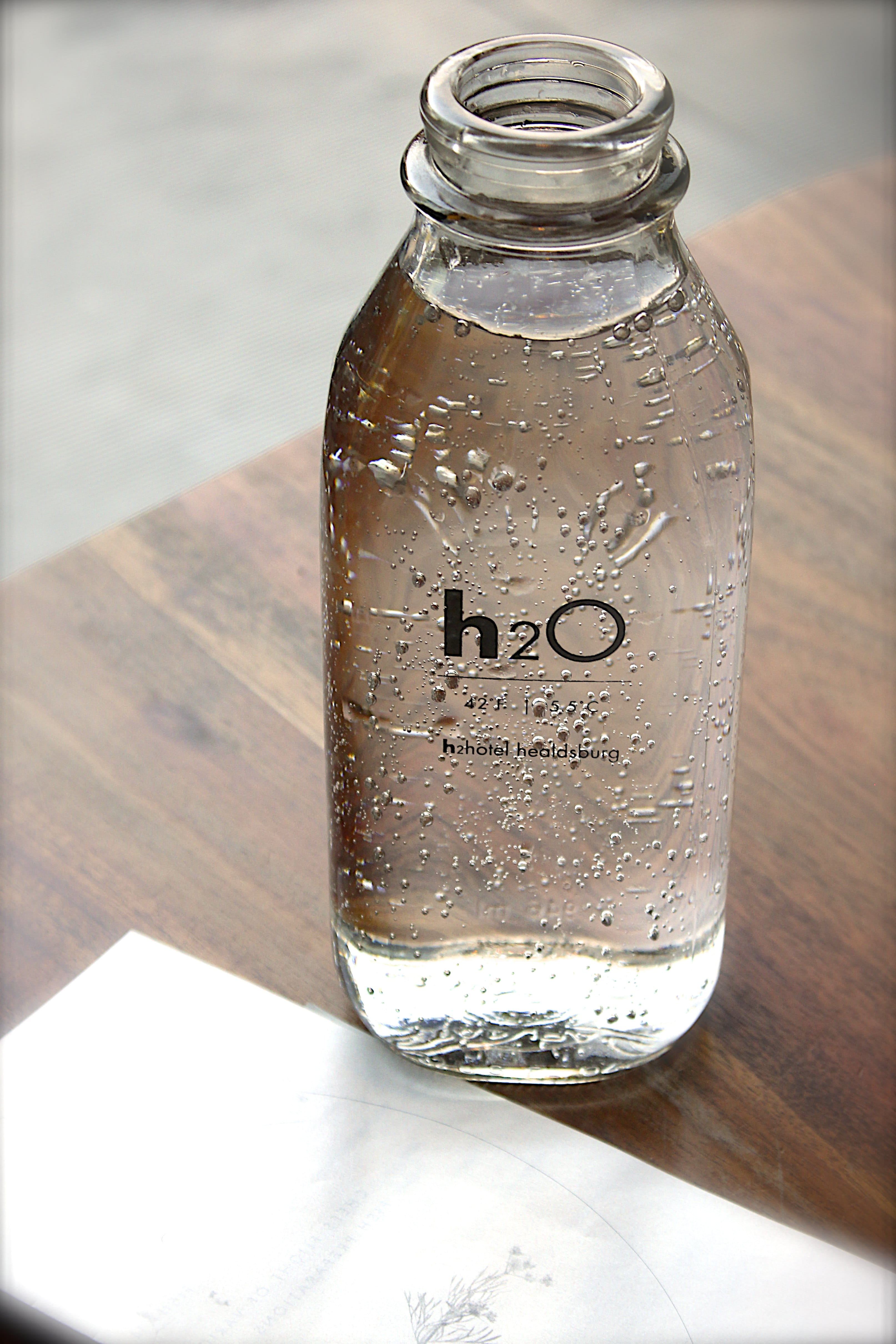 hydrate, freshness, jar, no people, water, close-up, table, text, transparent, food and drink, ho, bottle, glass, wood - material, food, focus on foreground, Phone HD Wallpaper