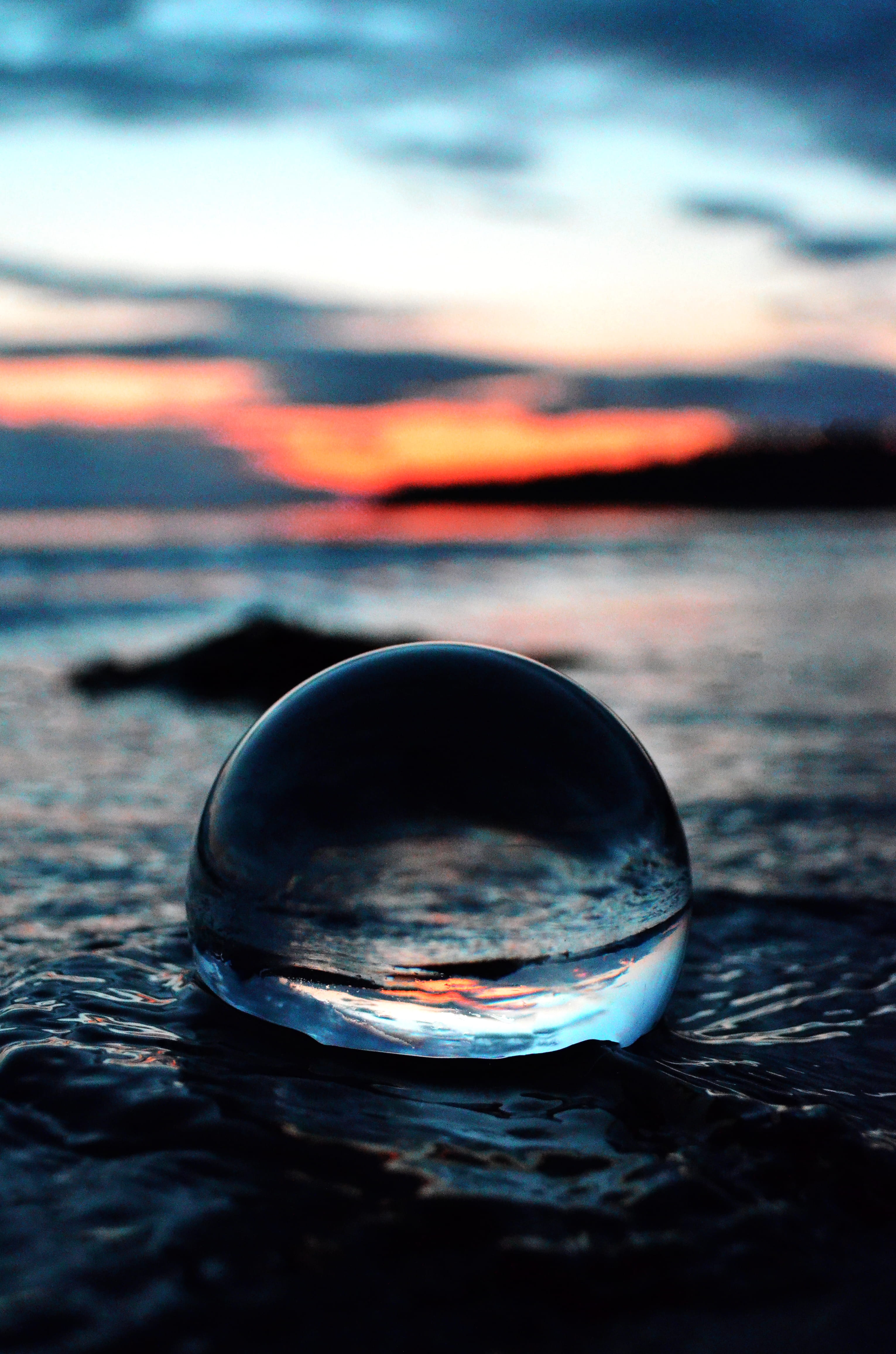 sunset, close-up, glass ball, shape, no people, shift, glass, ball, tranquility, sun, sphere, geometric shape, sea, crystal ball, landscape, circle, lens, Phone HD Wallpaper