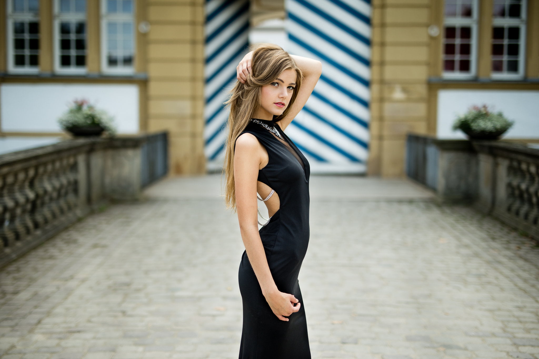 building exterior, 1080P, looking at viewer, lifestyles, blond hair, real people, side view, hands in hair, Lukas Welling, black dress, young women, outdoors, HD Wallpaper