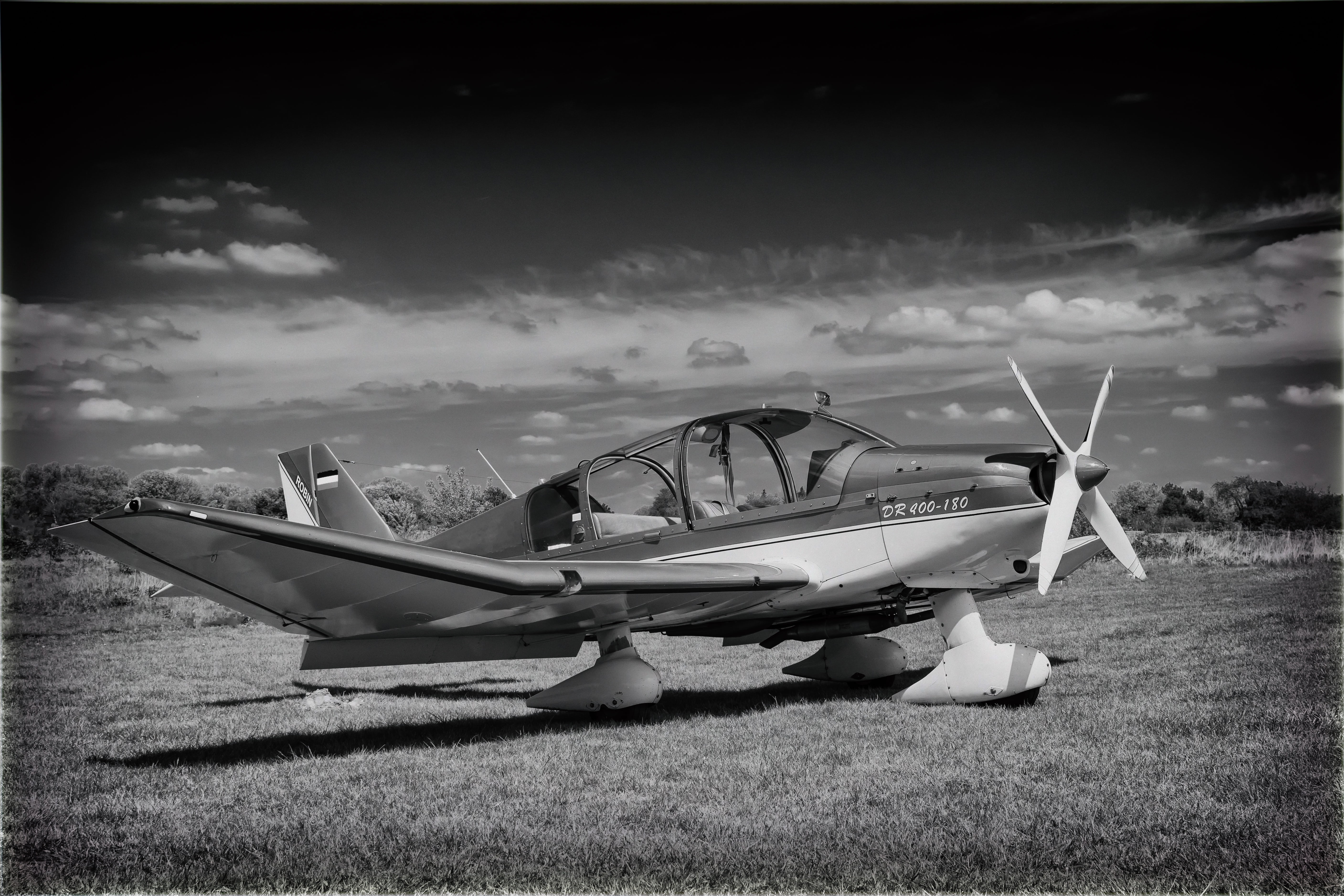 airplane, grass, sport aircraft, 5K, propeller, old, old-fashioned, grayscale, low-wing monoplane, travel, fly, togetherness, transportation, aviation, HD Wallpaper