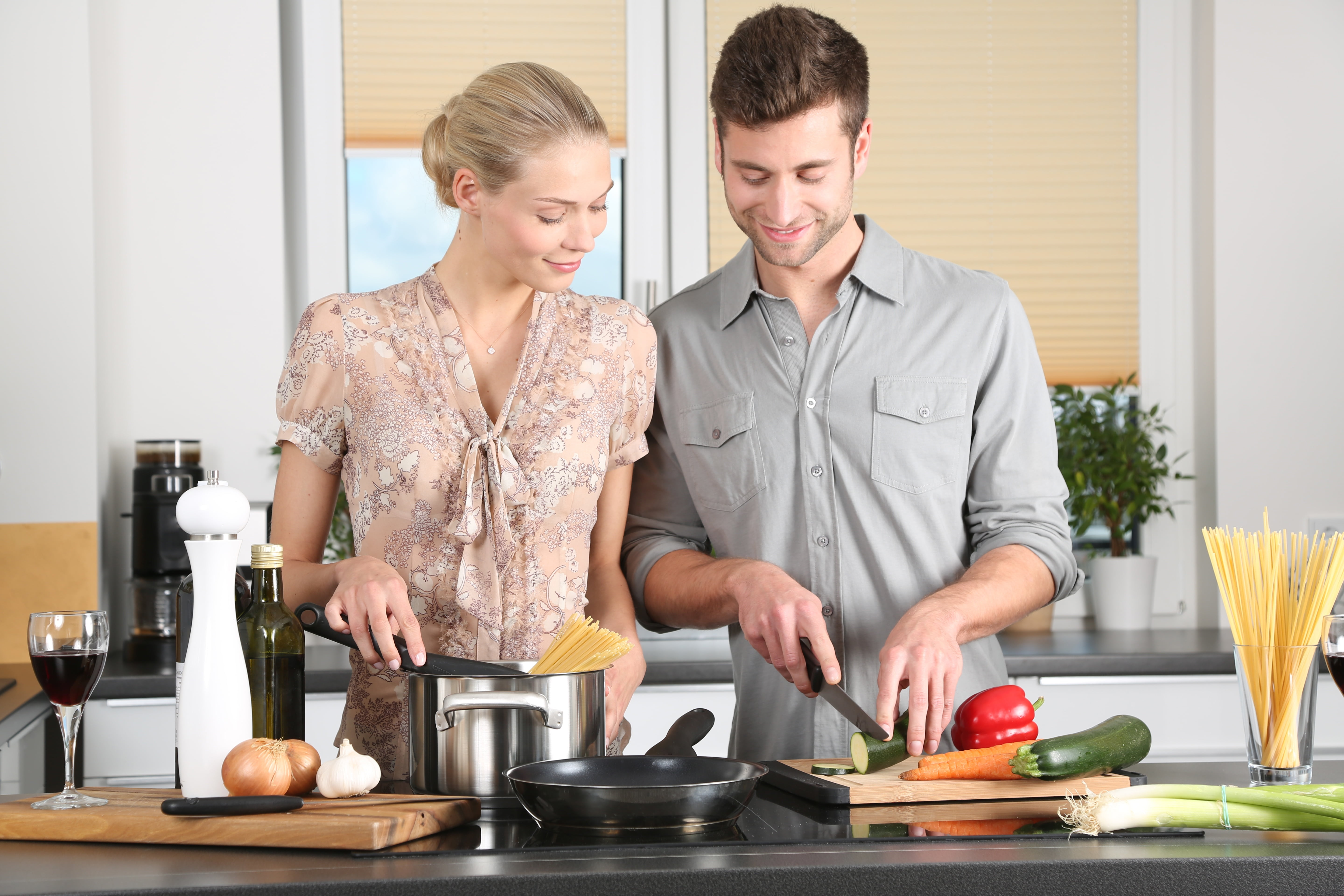 kitchen counter, indoors, preparing food, pretty, board, shirt, stove, domestic room, woman, cutting, dress, gray, human, two people, noodles, blond, adult, HD Wallpaper