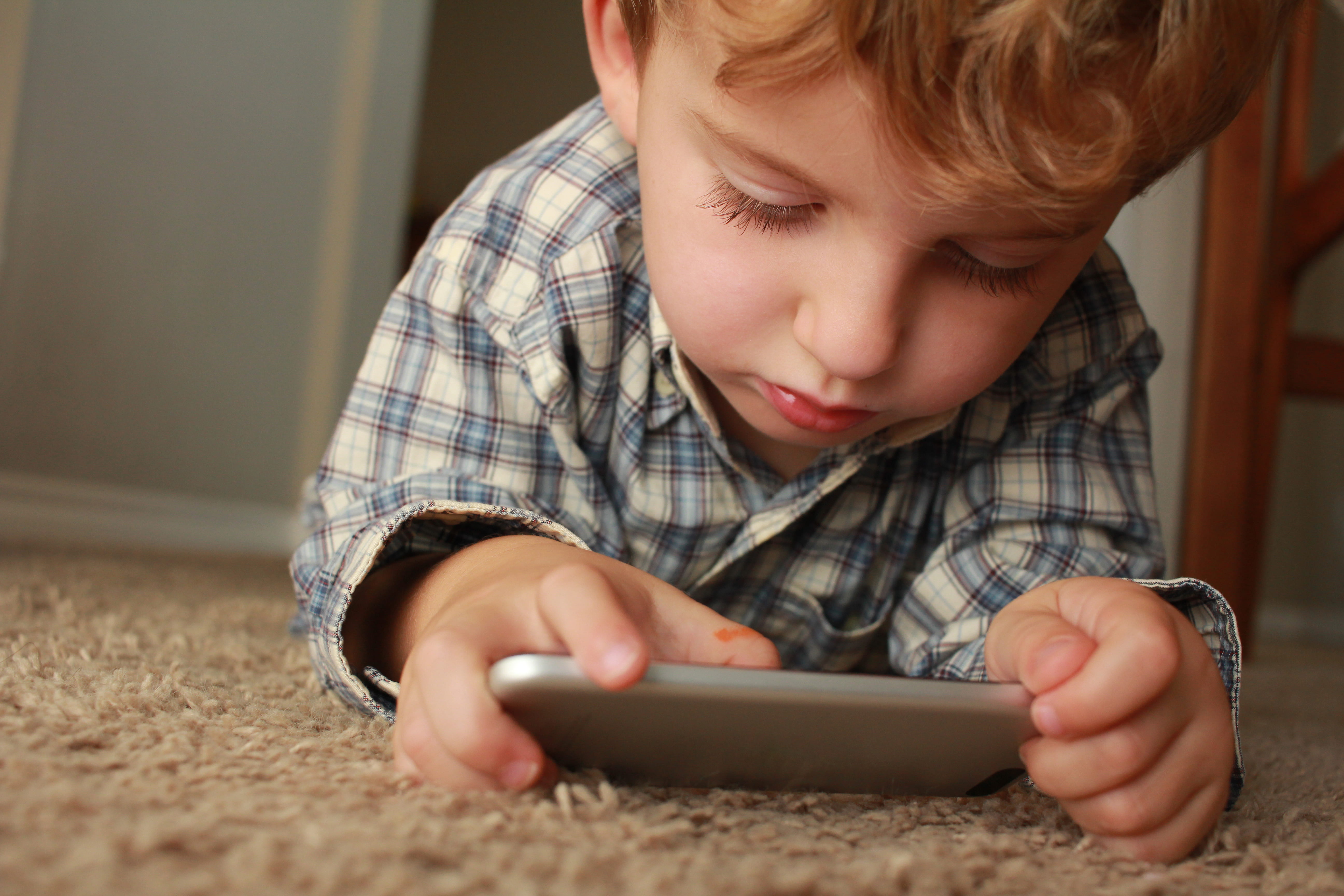 kid, kid playing on iphone, one person, looking, indoors, lying, digital tablet, blond hair, hair, holding, innocence, child, communication, brown, smartphone, HD Wallpaper