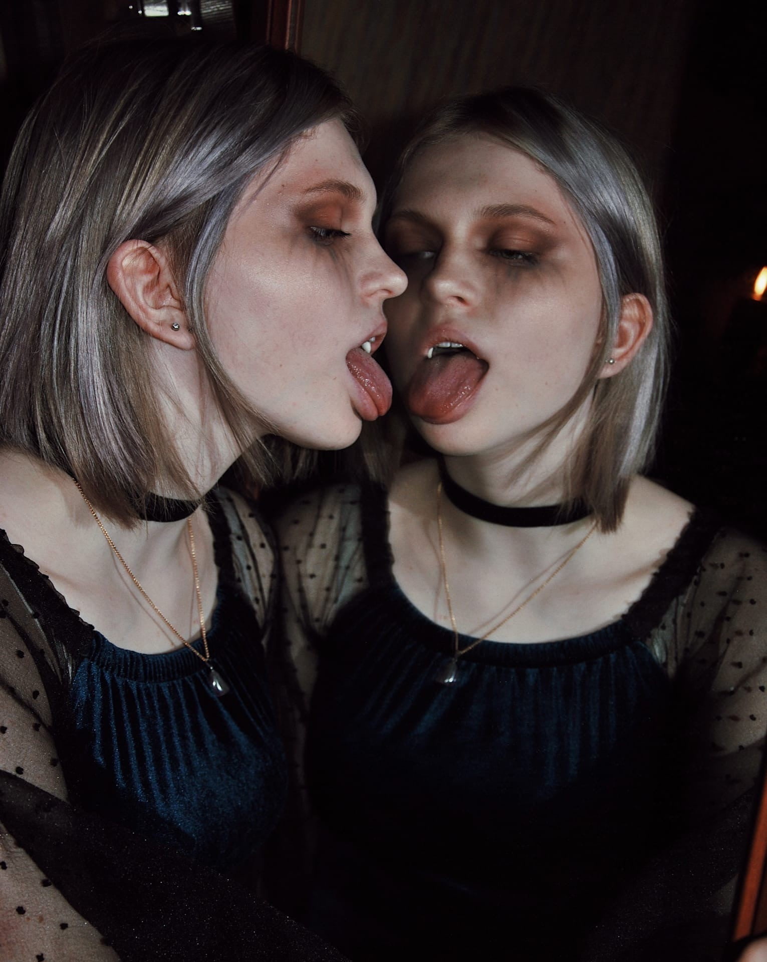young woman, looking below, choker, women indoors, mascara, open mouth, tongue out, earring, black clothing, eyeshadow, mirror, women, 1080P, natural light, Phone HD Wallpaper