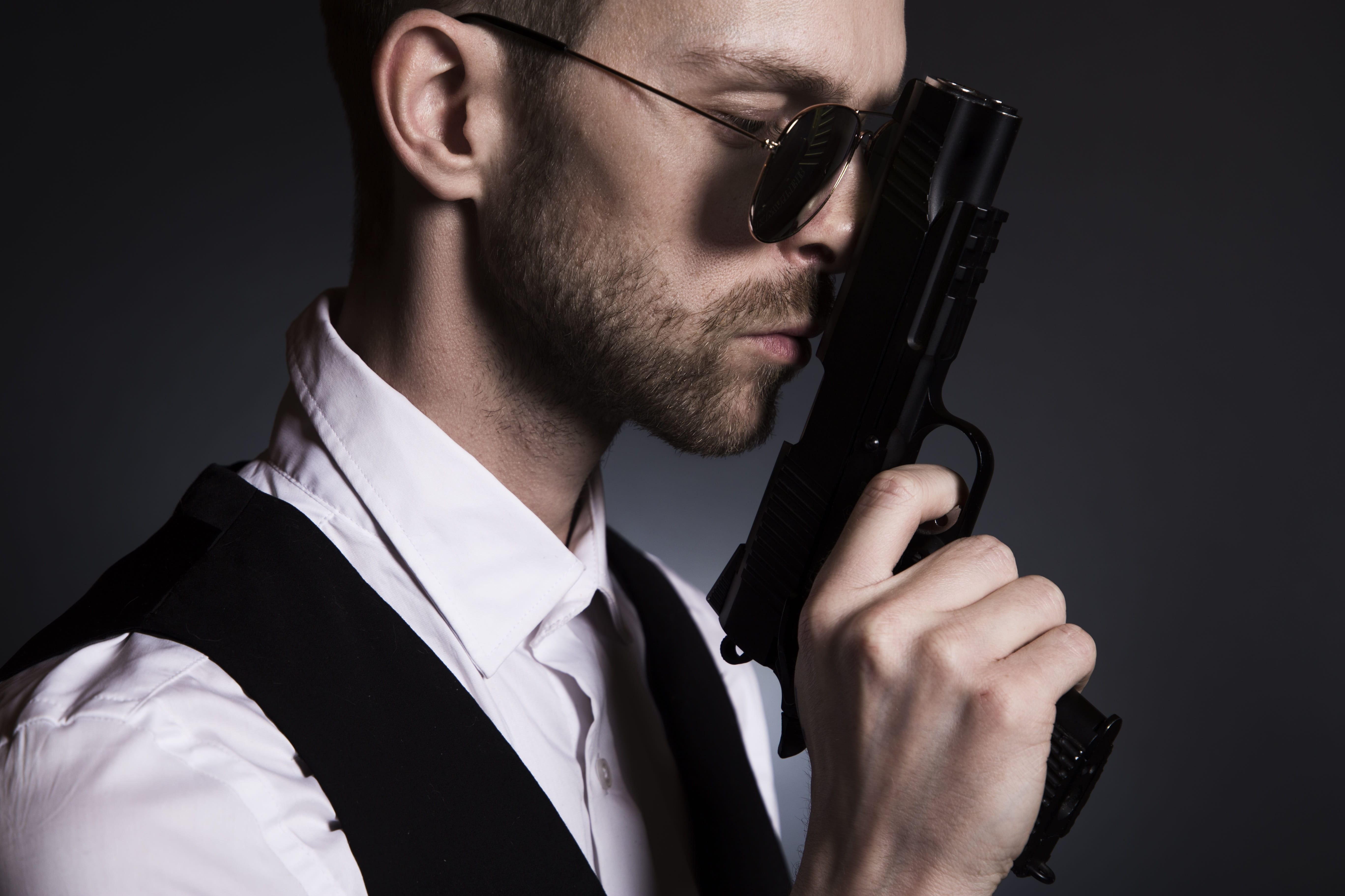 one person, murder, vengeance, holding, man, menswear, weapon, black background, crime, aggression, mafia, front view, handgun, kill, spy, hitman, guard, HD Wallpaper