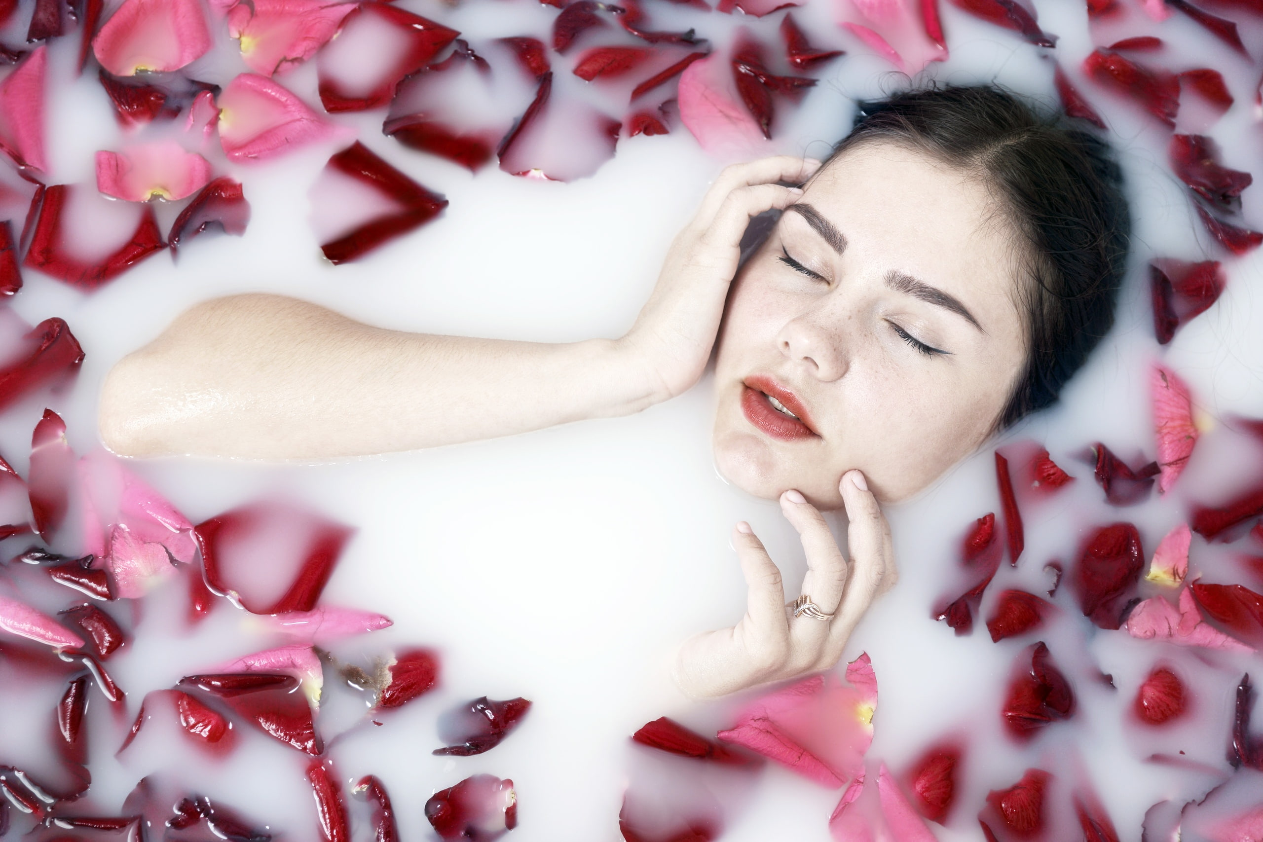 real people, young adult, headshot, lifestyles, lying down, closed eyes, indoors, high angle view, body part, human arm, model, beautiful woman, milk, face, HD Wallpaper