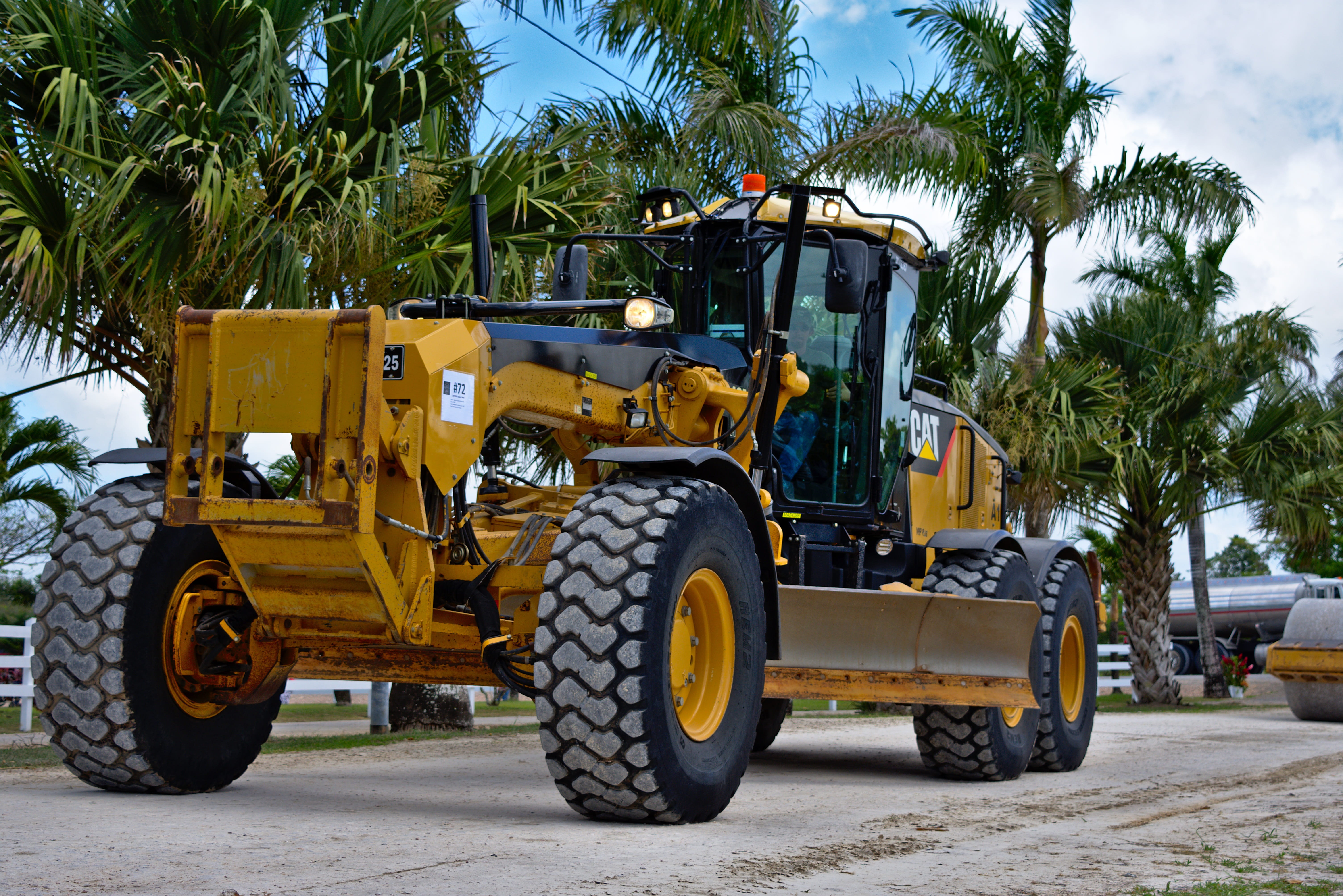 scraper, construction vehicle, plant, palm tree, day, land vehicle, industry, bulldozer, hydraulic, outdoors, sunlight, nature, transportation, road, grader, HD Wallpaper