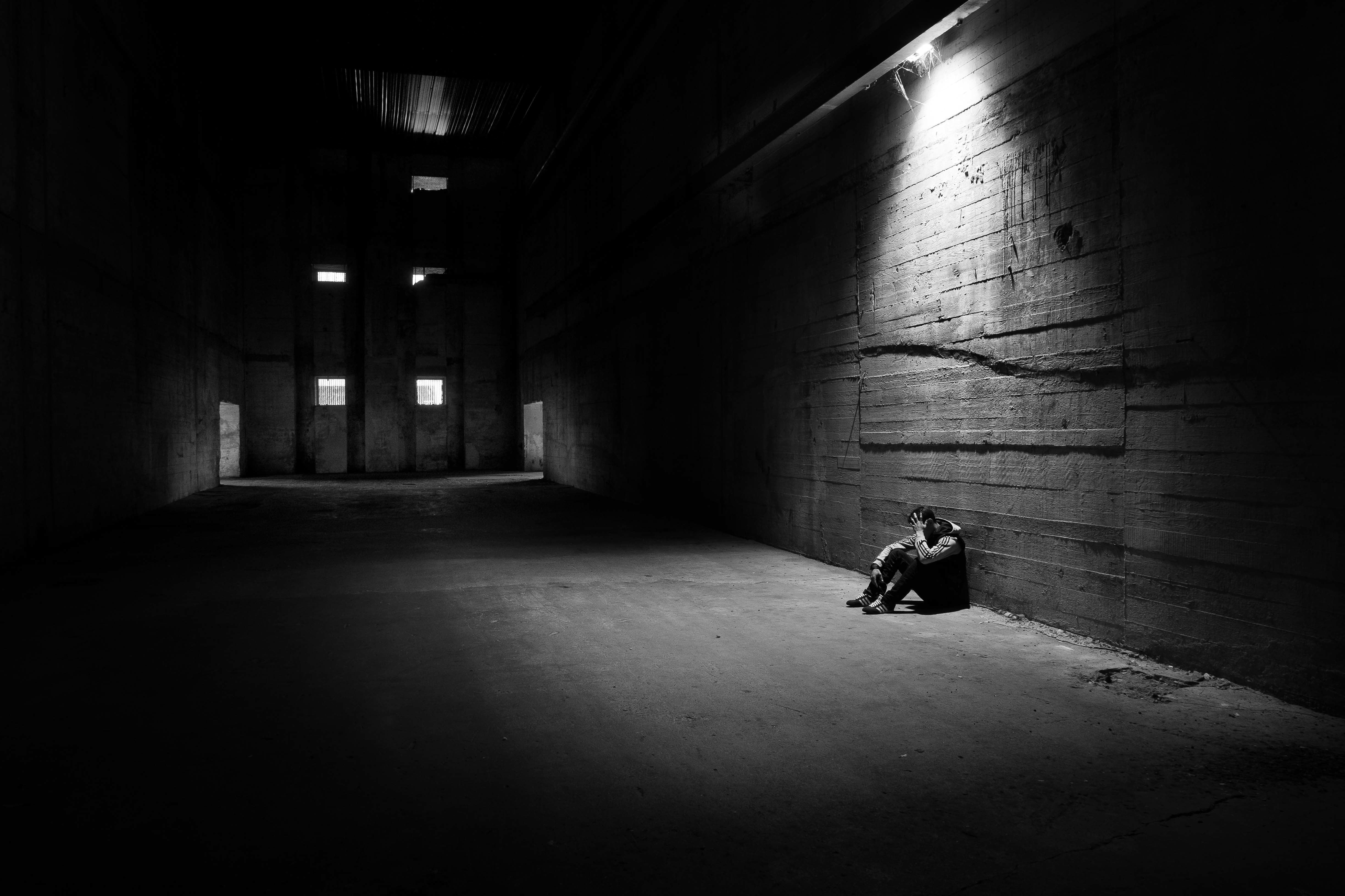 men, illuminated, light - natural phenomenon, building, sitting, indoors, adult, loneliness, tunnel, wall - building feature, light, one person, hangar, HD Wallpaper