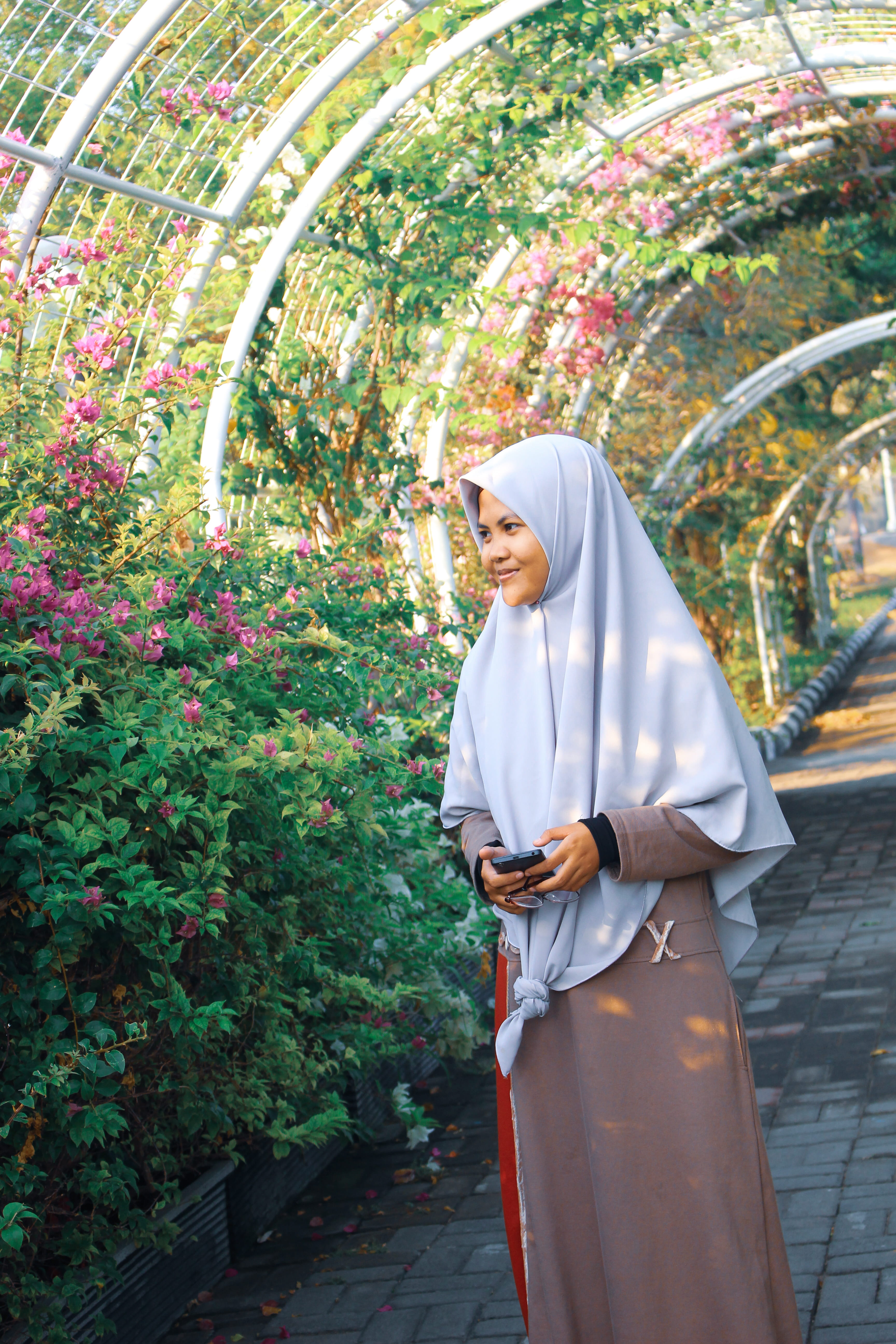 headscarf, girl, real people, hijab, indonesia, flower, women, architecture, traditional clothing, one person, standing, adult, clothing, day, plant, nature, Phone HD Wallpaper