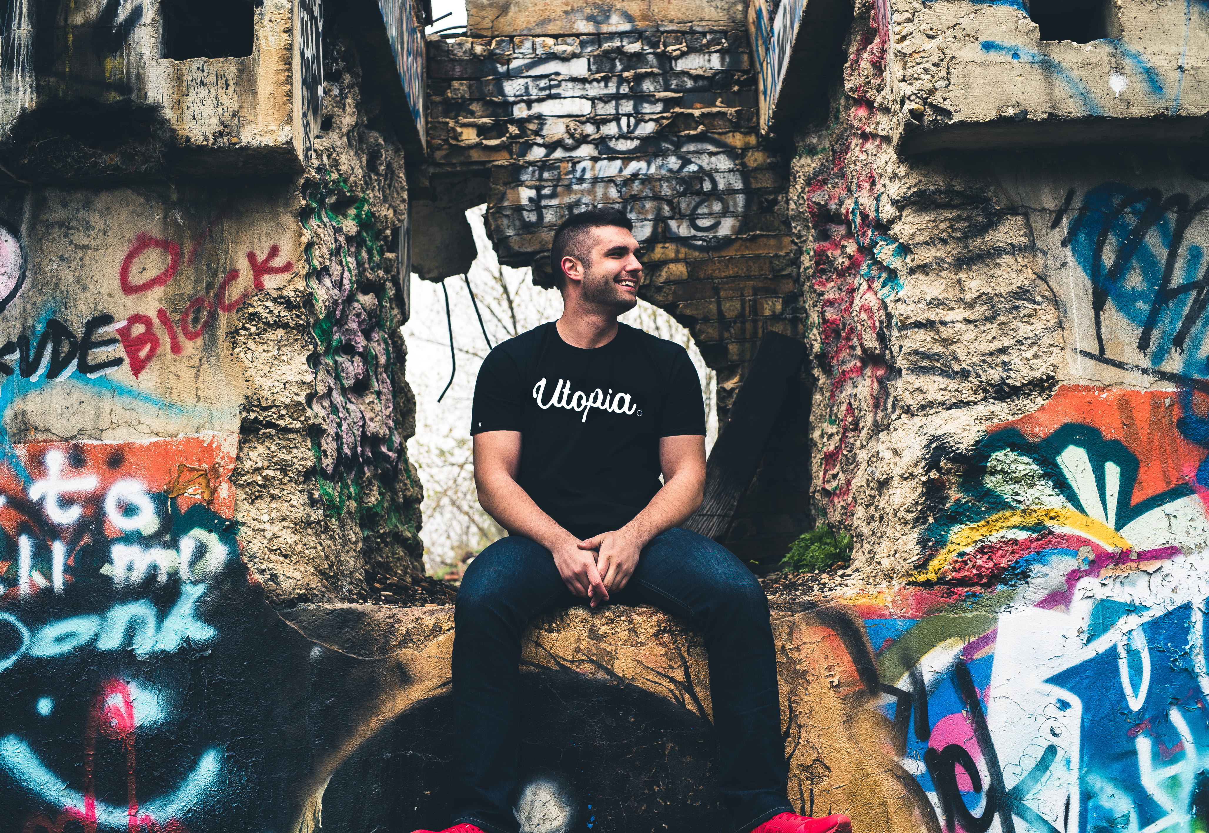 wearing, people, printed, real people, creativity, man, sitting, lifestyles, front view, text, ledge, young men, day, utopia, black, street art, wall - building feature, HD Wallpaper