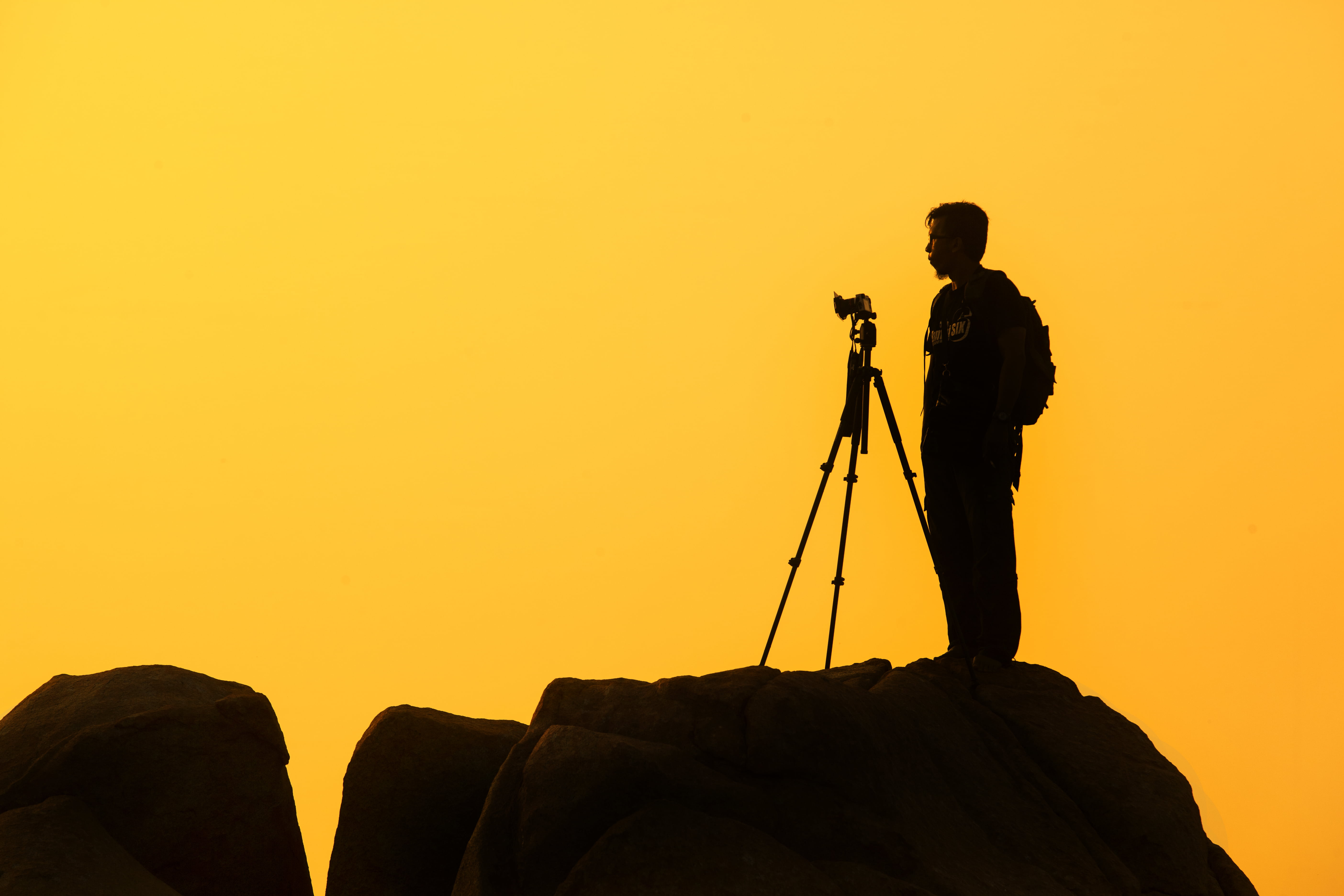 yellow, standing, nature, sky, men, orange color, adults only, photographer, shadow, rock, man, full length, silhouette, tripod, 5K, camera, rock - object, HD Wallpaper