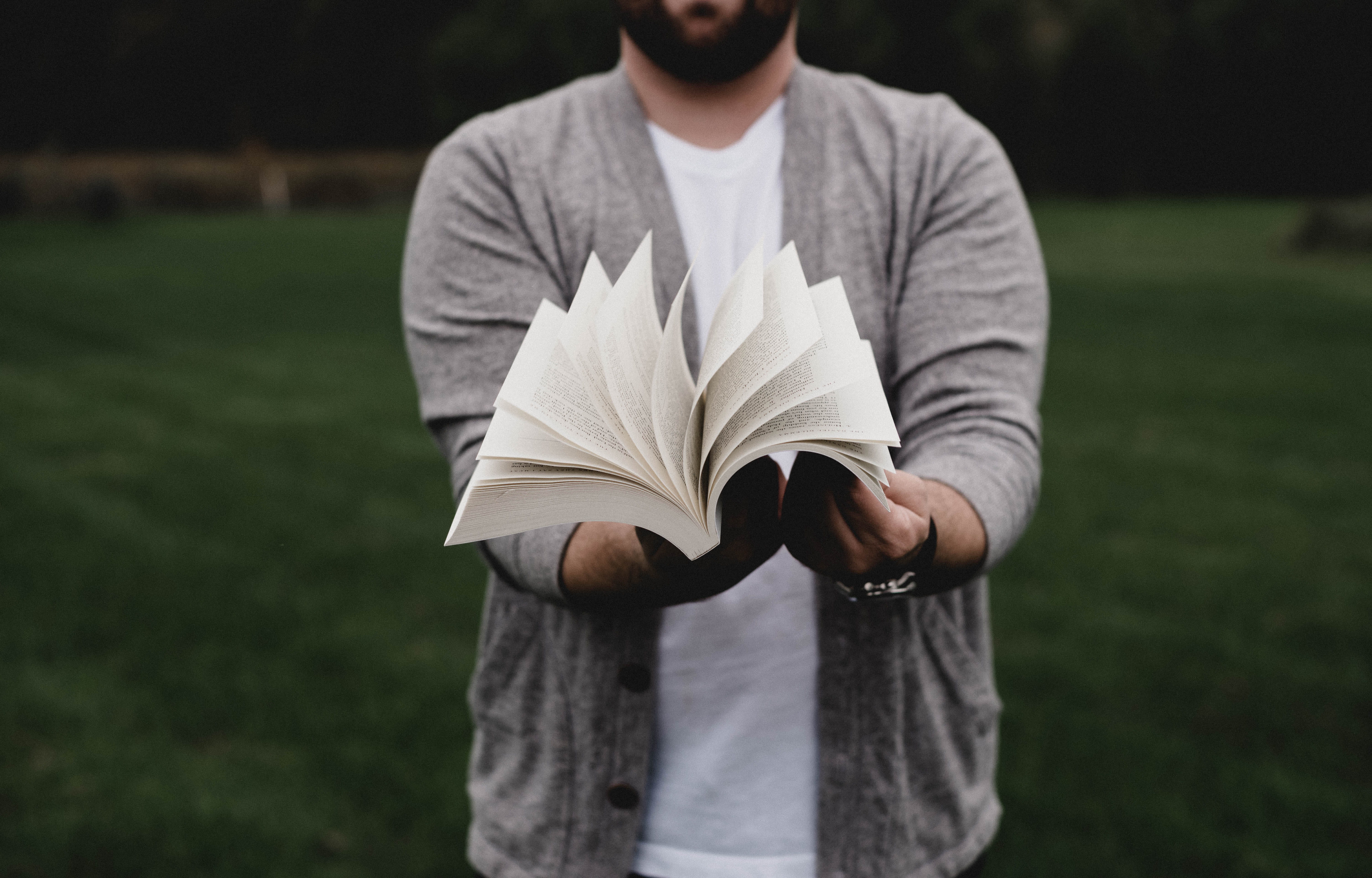 person, cardigan, casual Clothing, literature, outdoor, beard, opening, reading, holding, fashion, human Hand, pages, one Person, book, field, education, HD Wallpaper